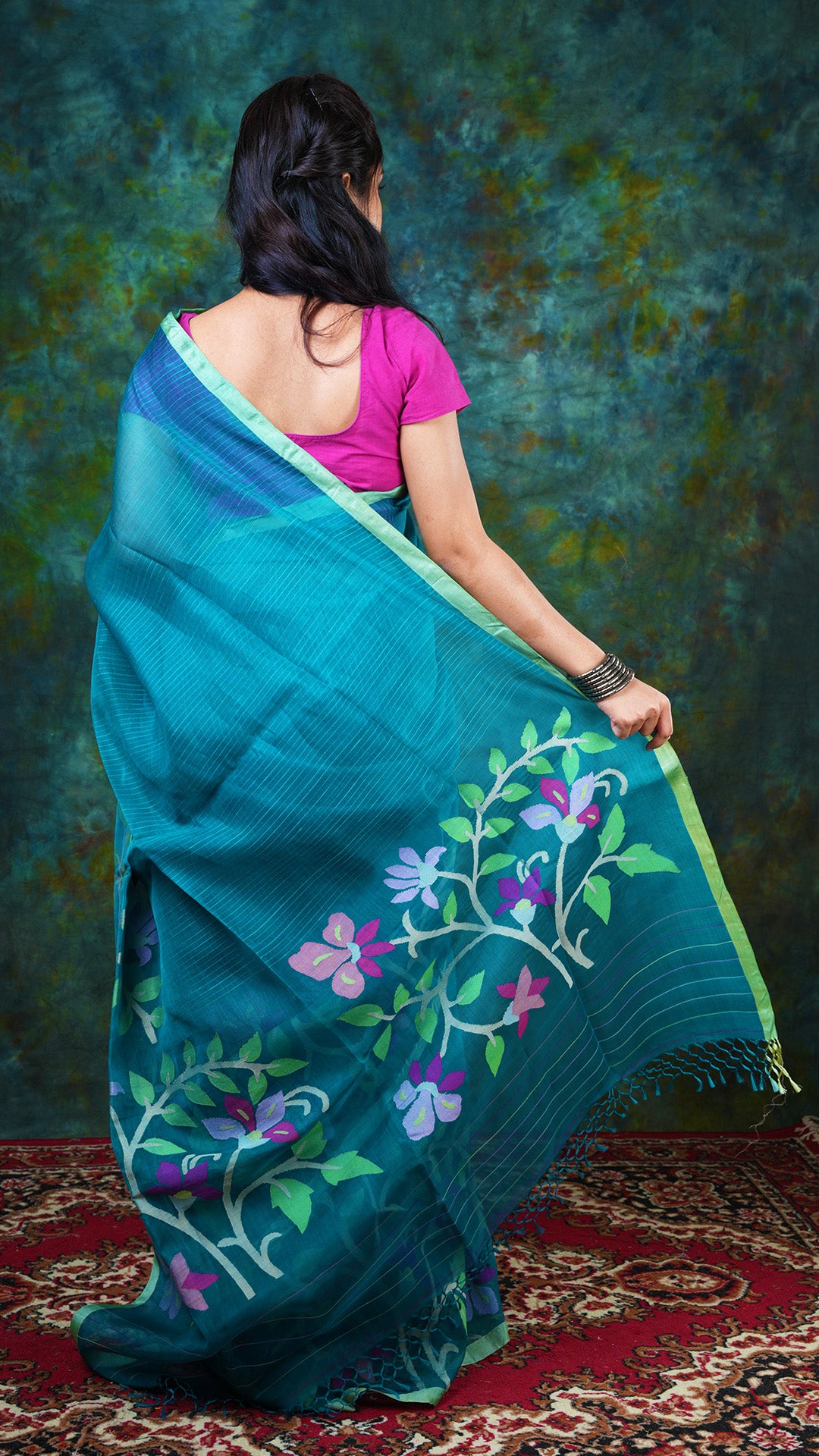 A emerald coloured muslin saree