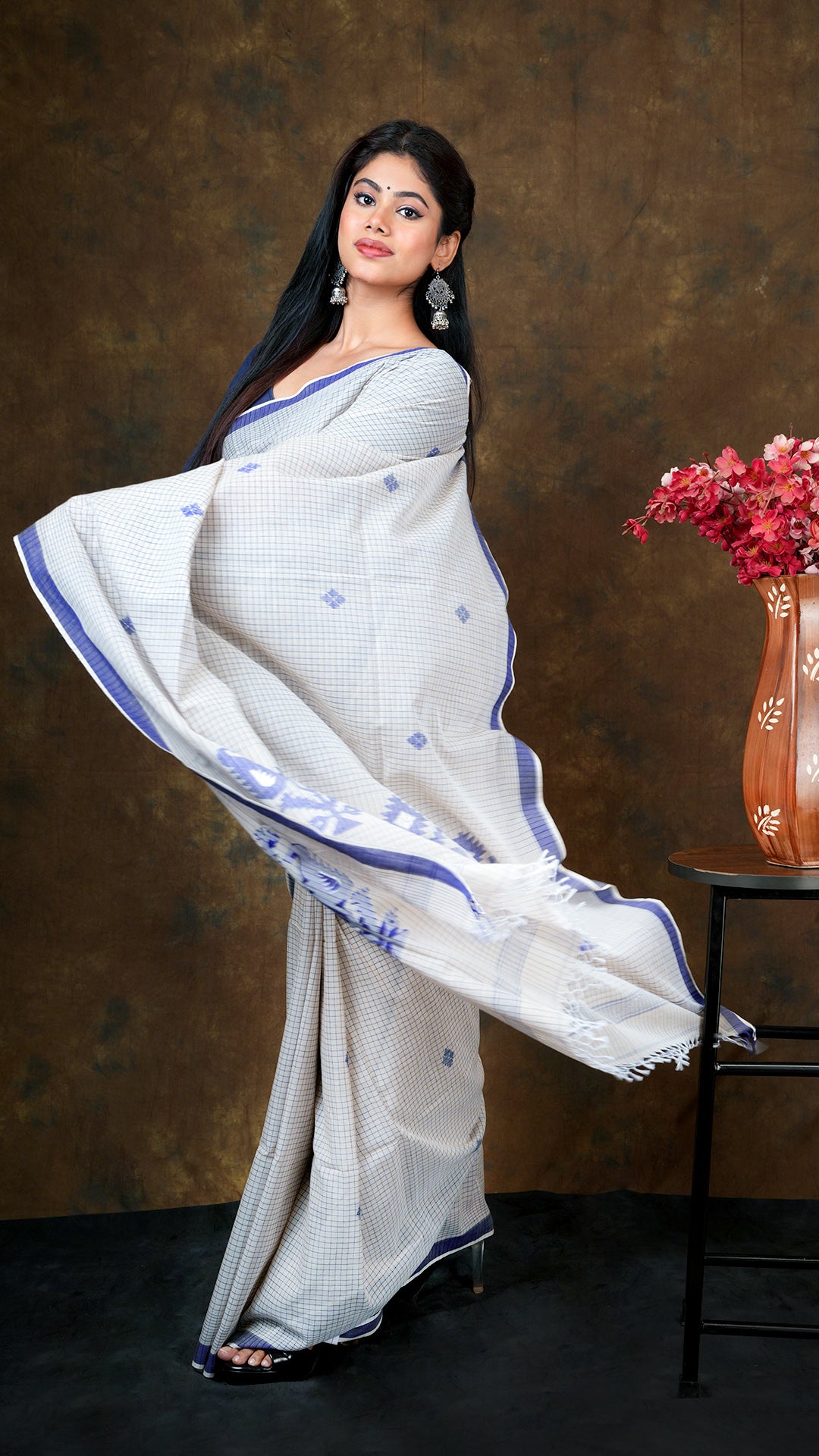 An off white with blue check saree