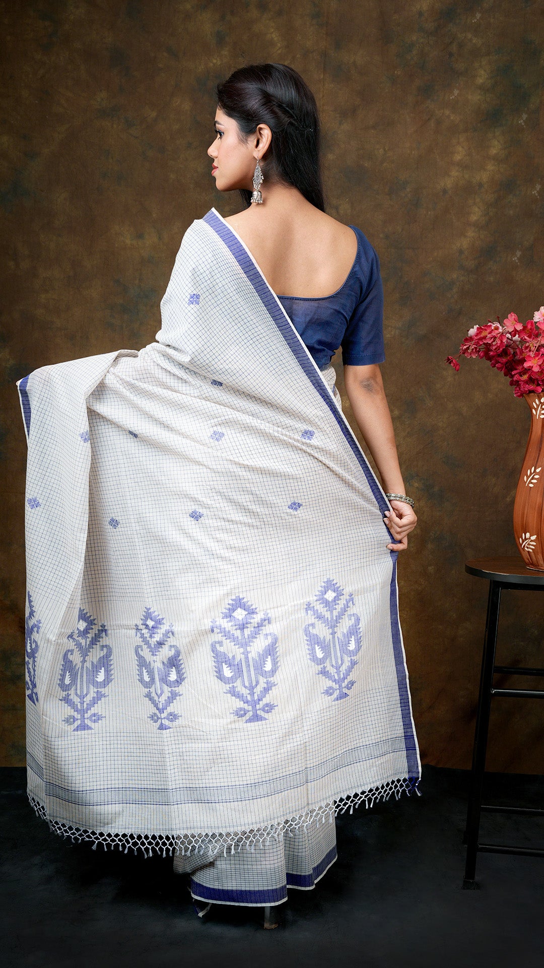 An off white with blue check saree