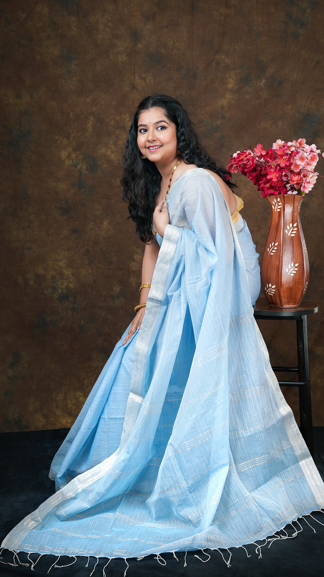 A sky blue coloured tangail saree