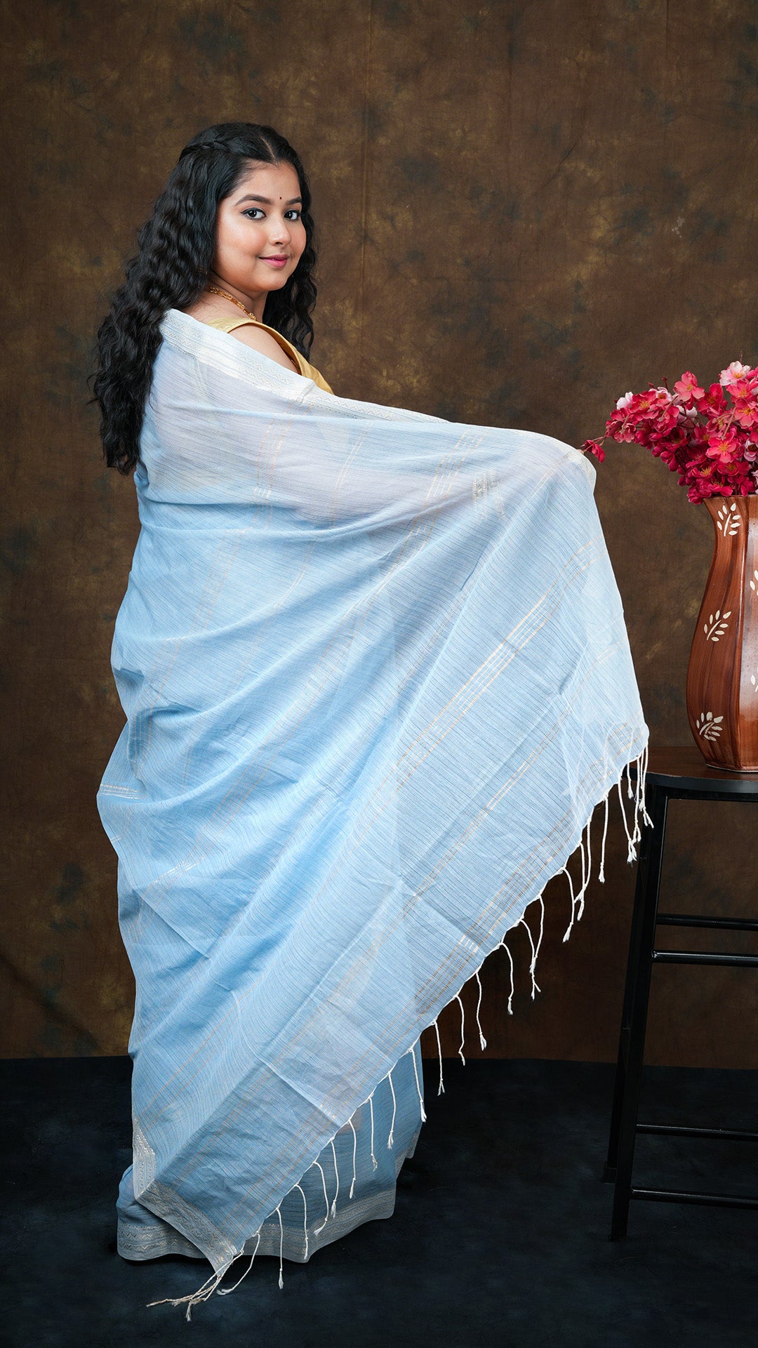 A sky blue coloured tangail saree