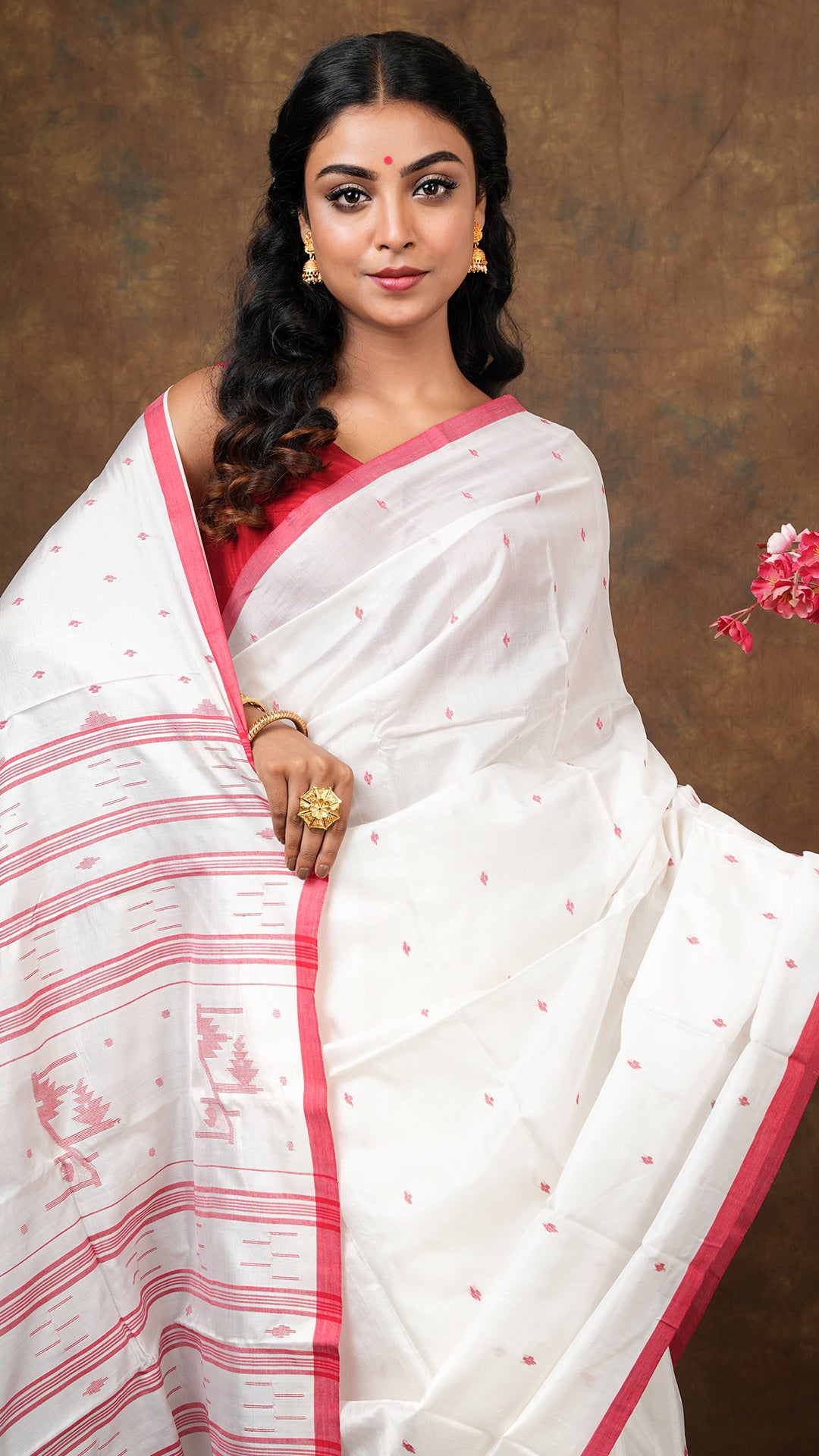 An off white red silk saree
