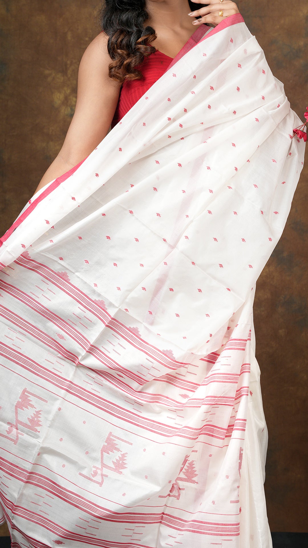 An off white red silk saree