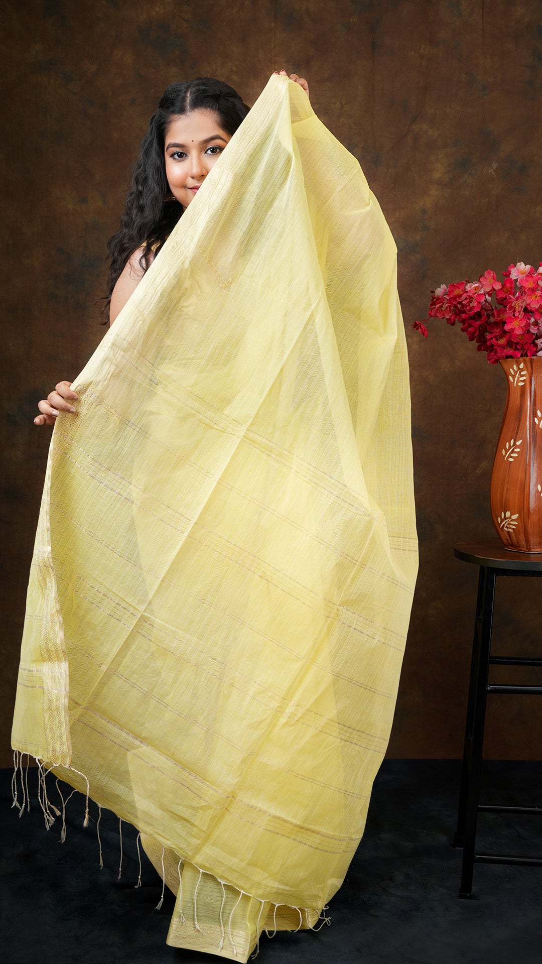 A lemon yellow tangail saree