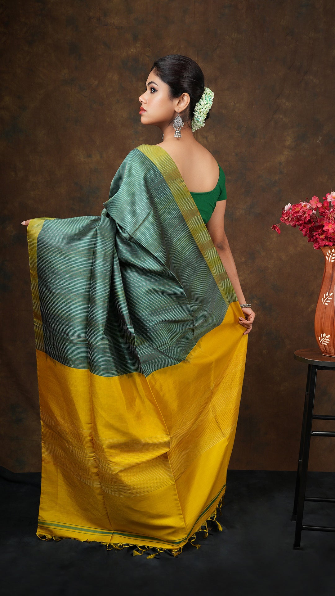 A dark green silk saree