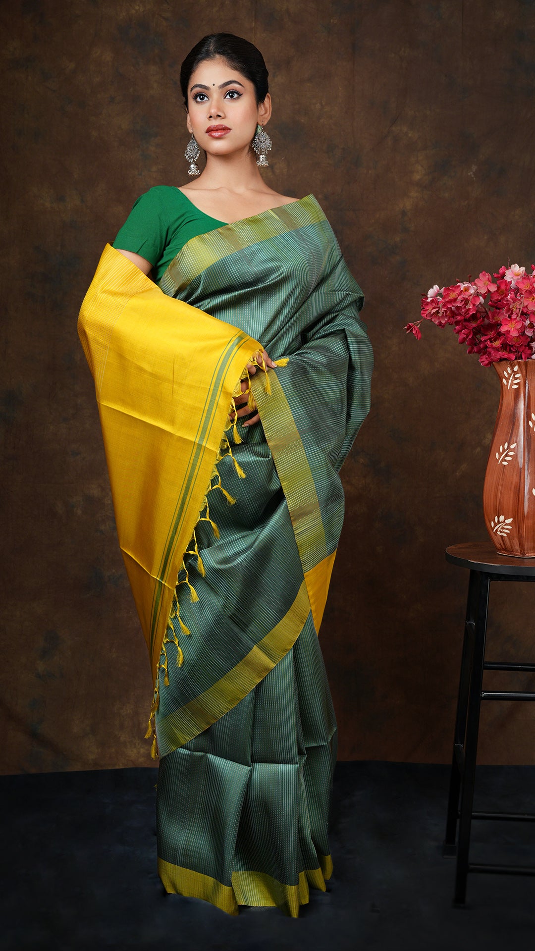 A dark green silk saree