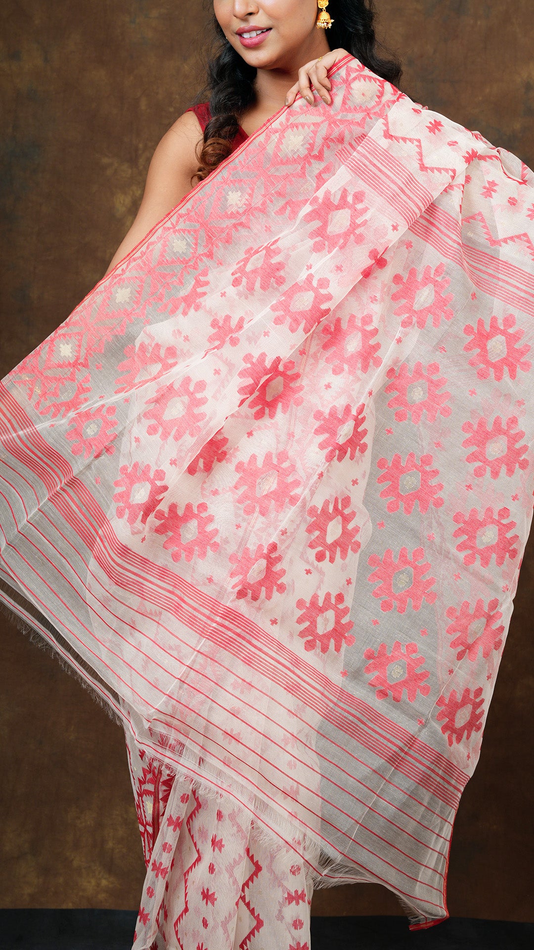 An off white and red muslin jamdani saree