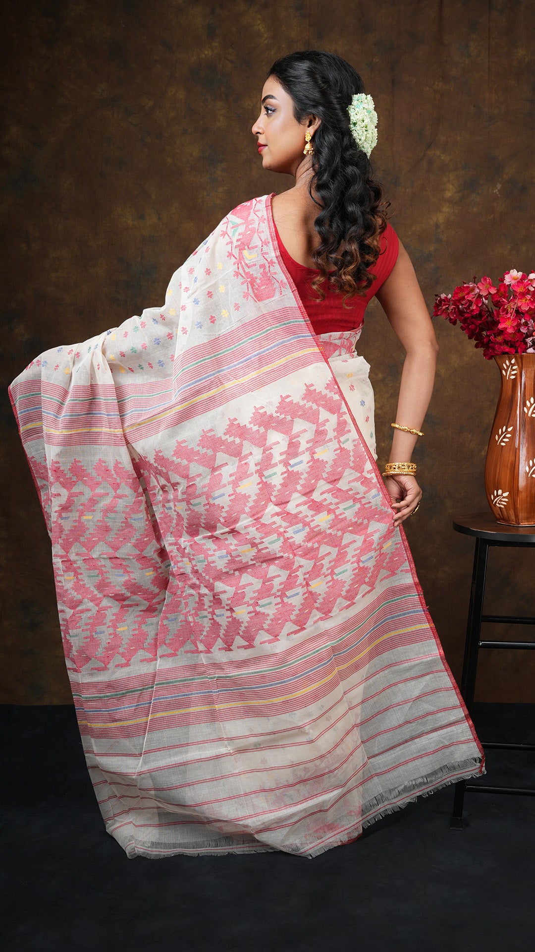 An off white with multi colour jamdani saree
