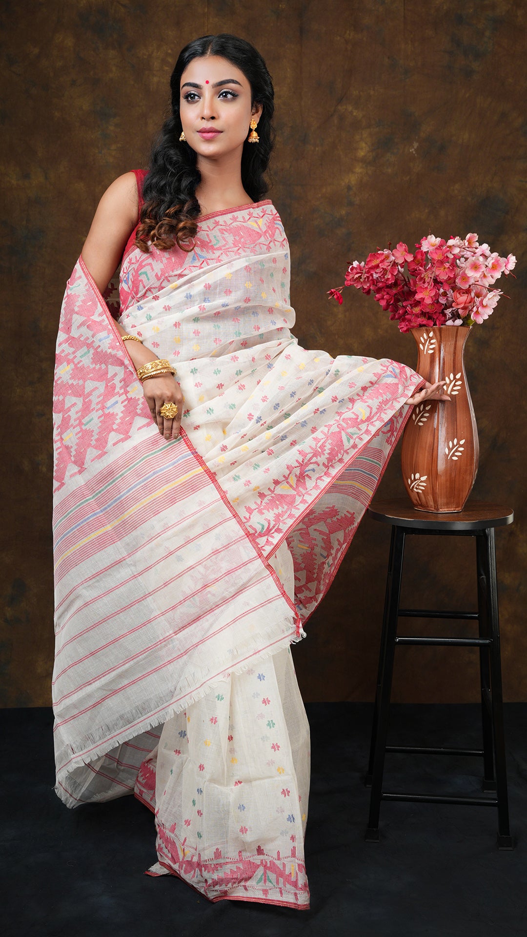 An off white with multi colour jamdani saree
