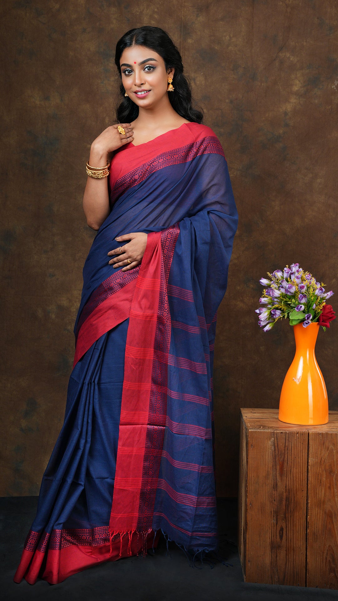A navy blue with red tangail saree