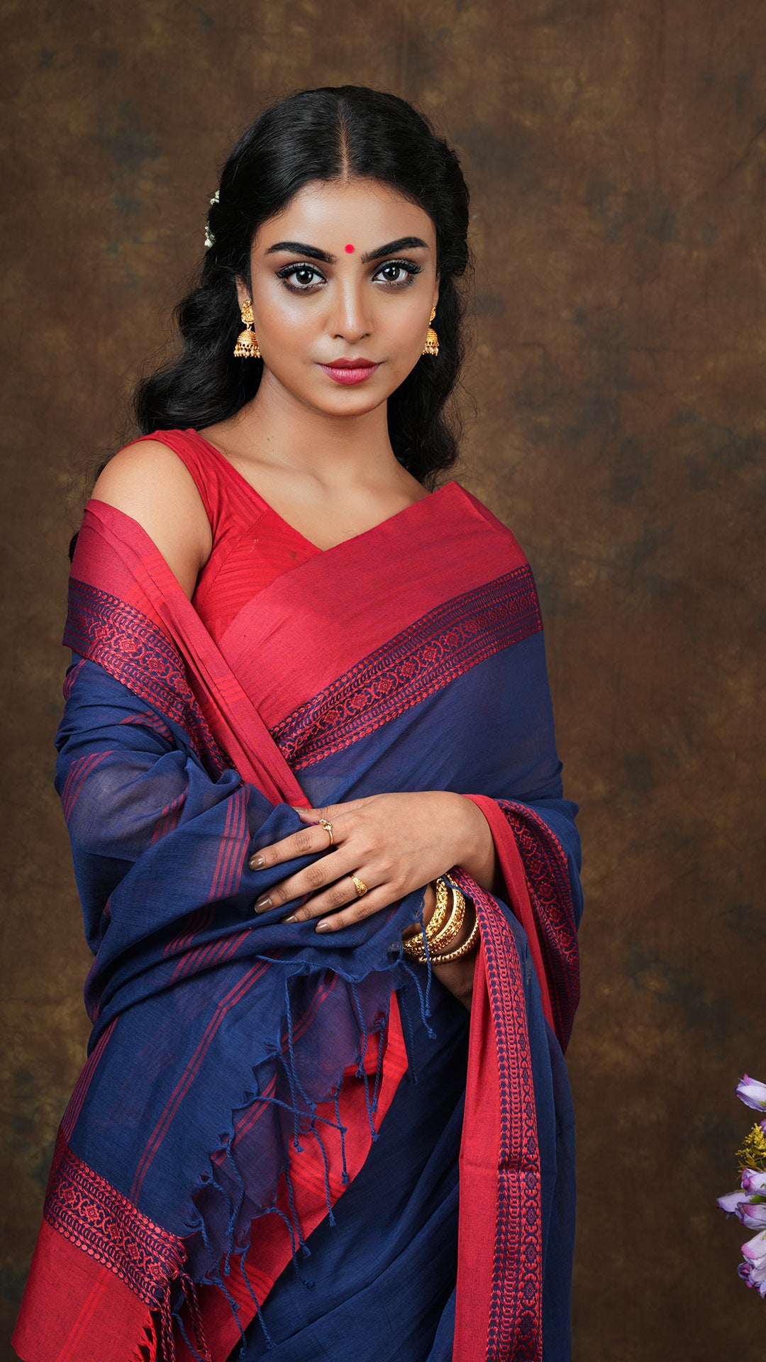 A navy blue with red tangail saree