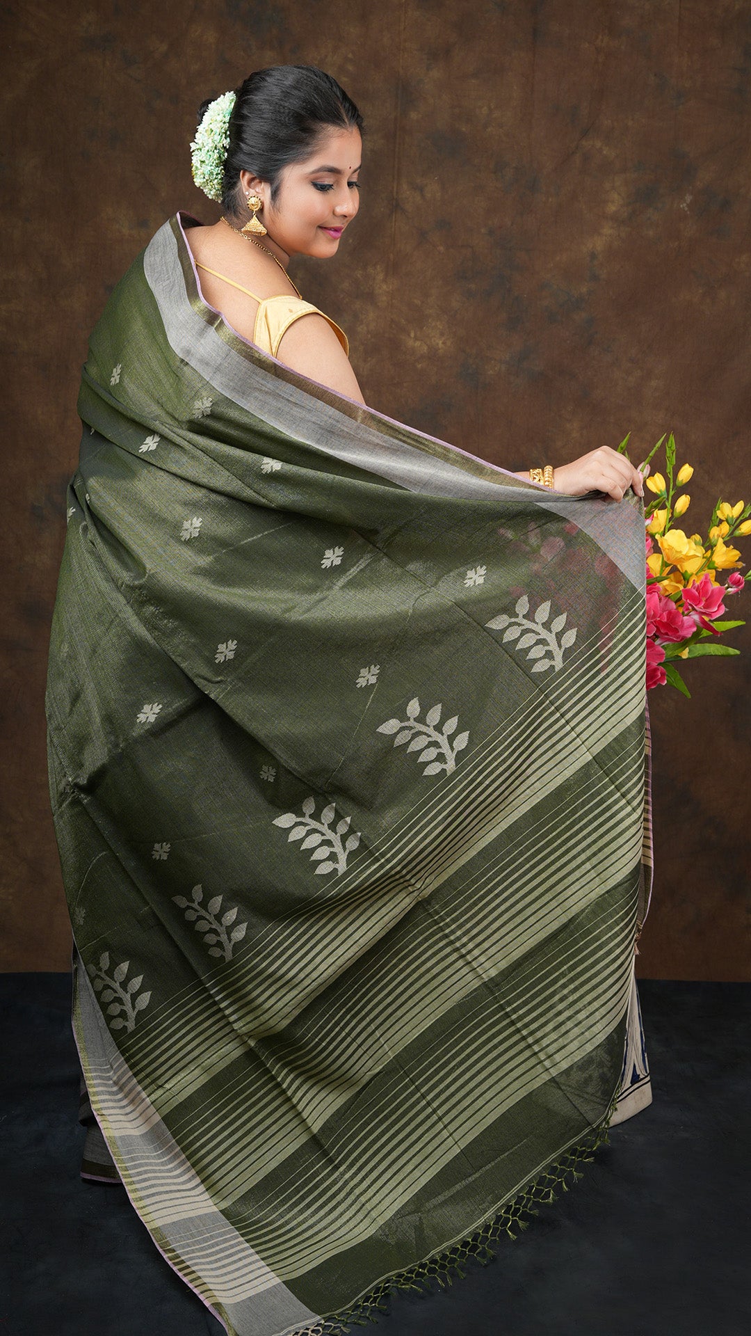 A blackish green tissue saree