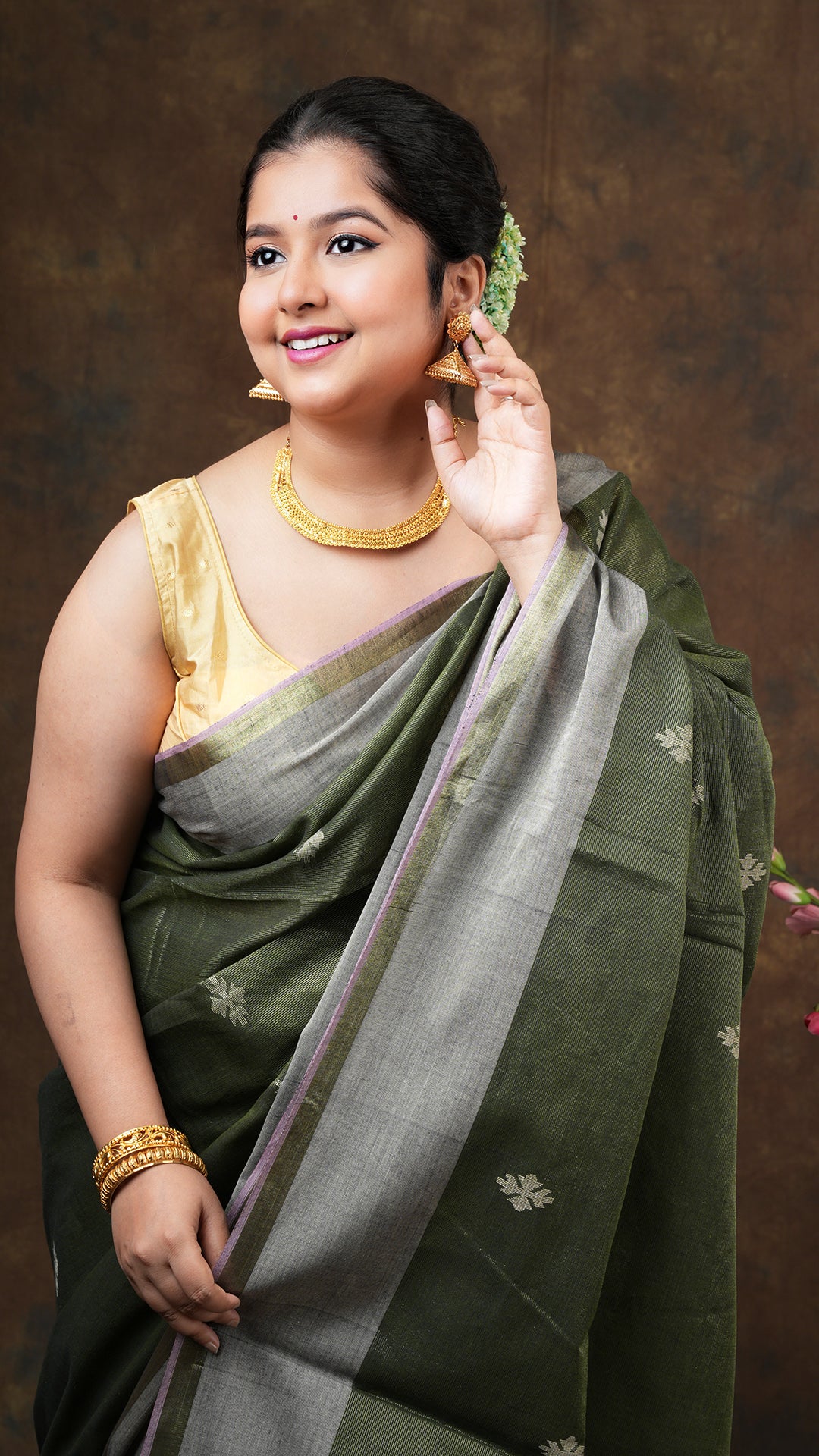 A blackish green tissue saree