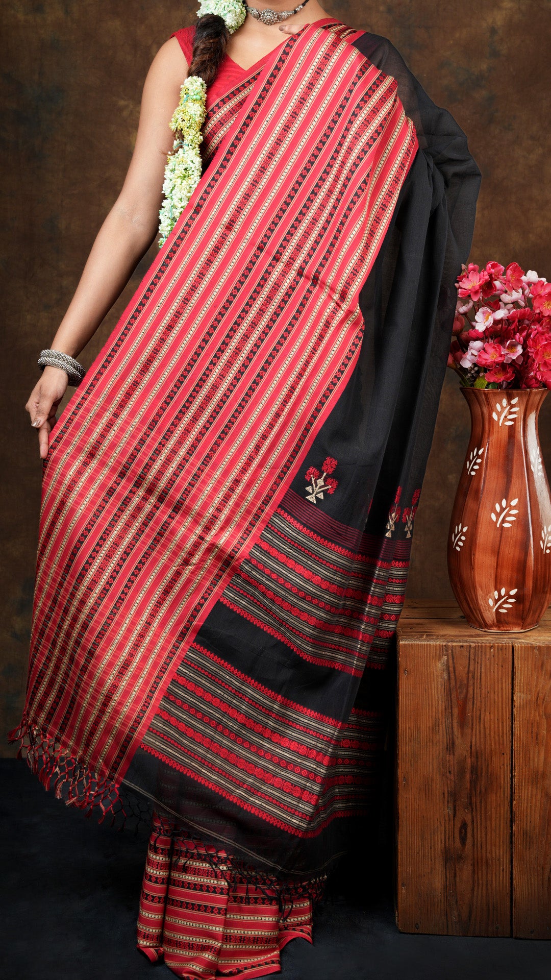 A black and red tangail saree