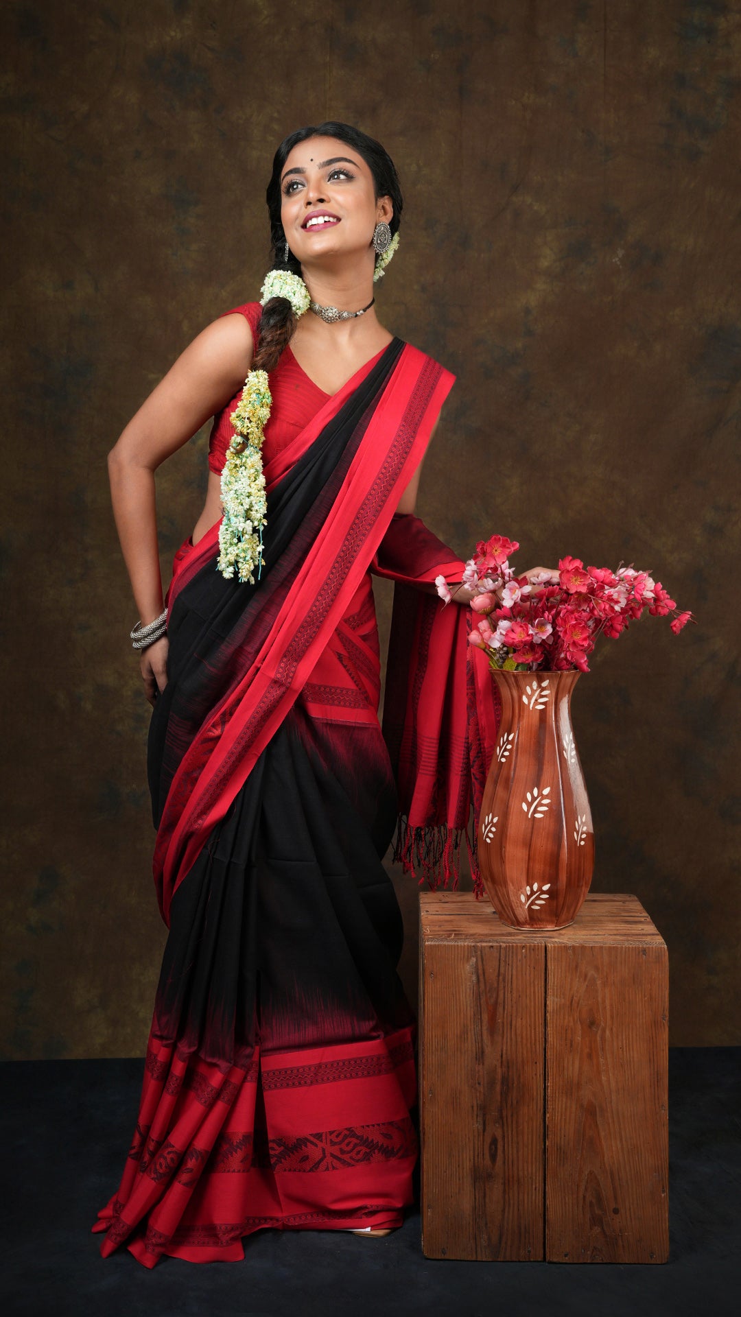 A black tangail saree with red border