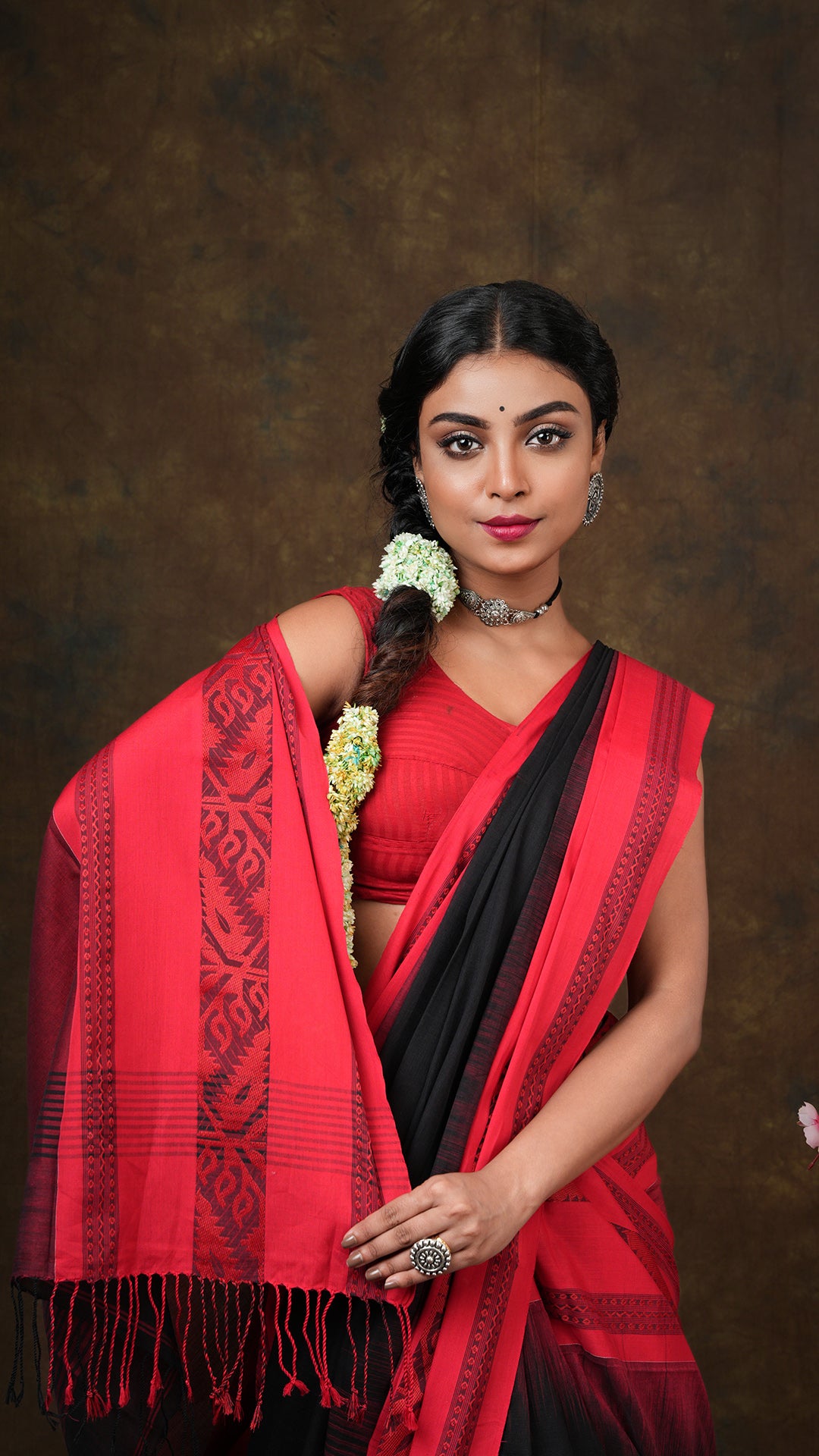 A black tangail saree with red border