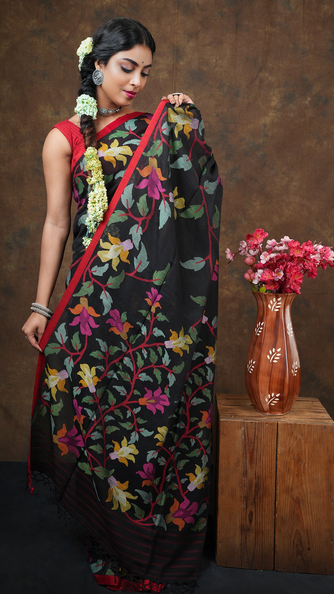A black with multi coloured dhakai