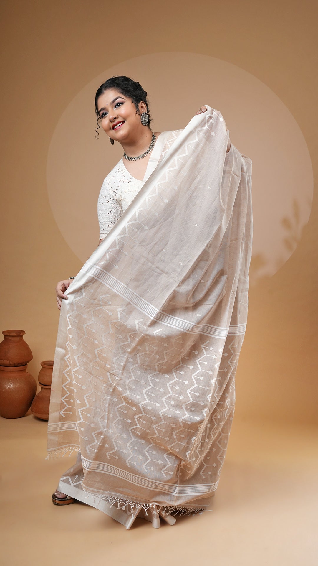 A fawn colour dhakai saree