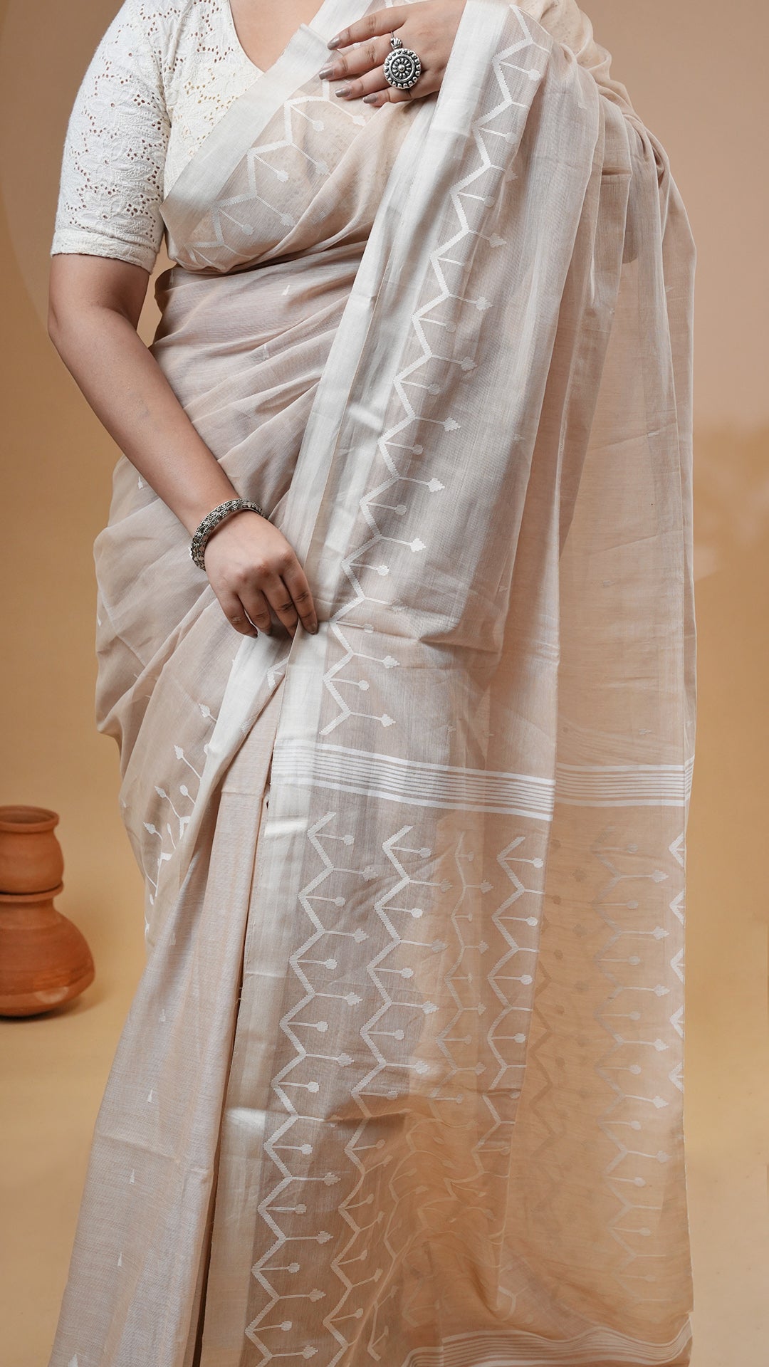A fawn colour dhakai saree