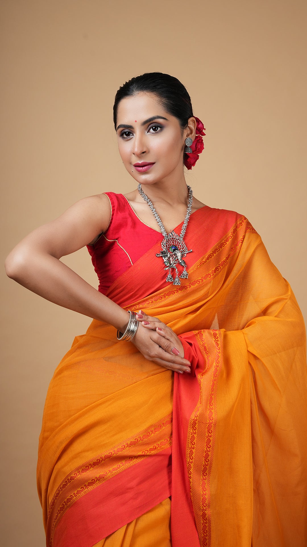 A golden yellow tangail saree