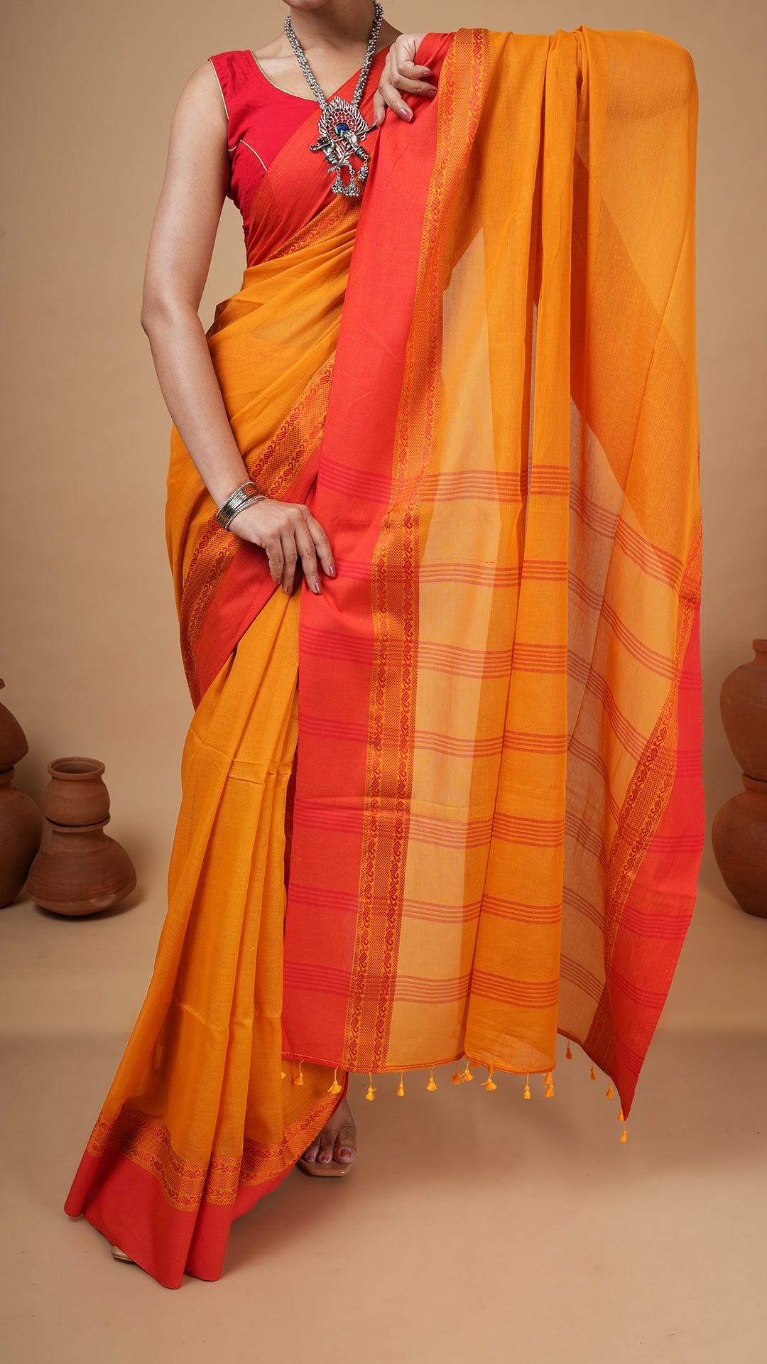 A golden yellow tangail saree