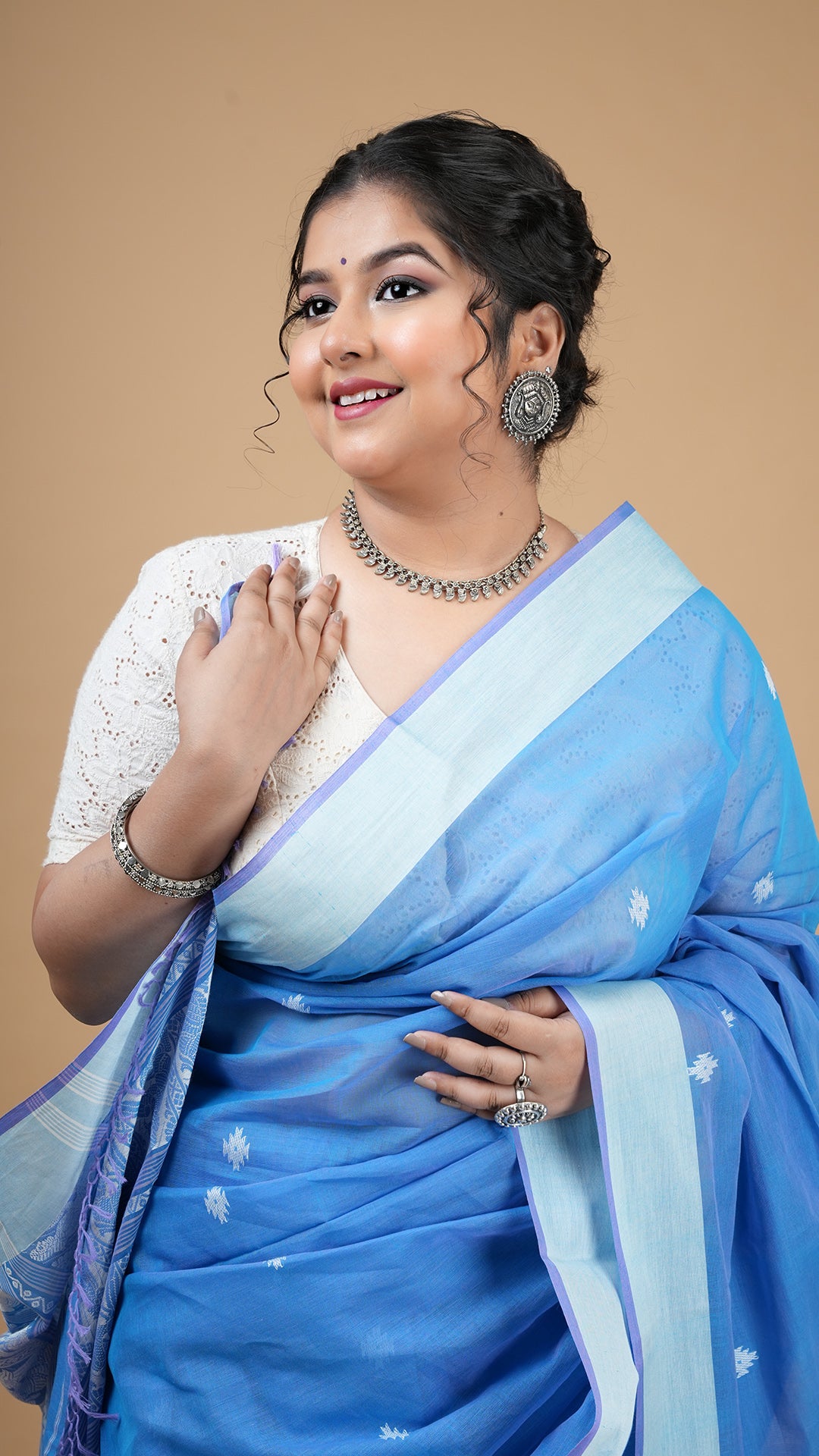 A blue and white tangail saree