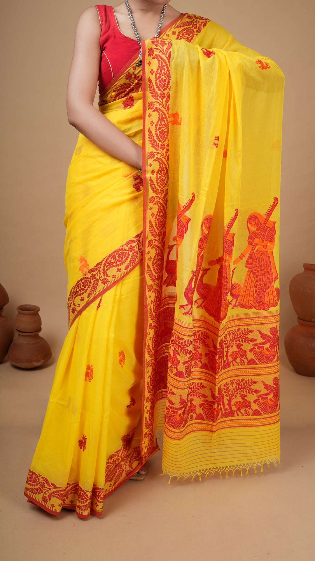 A bright yellow tangail saree