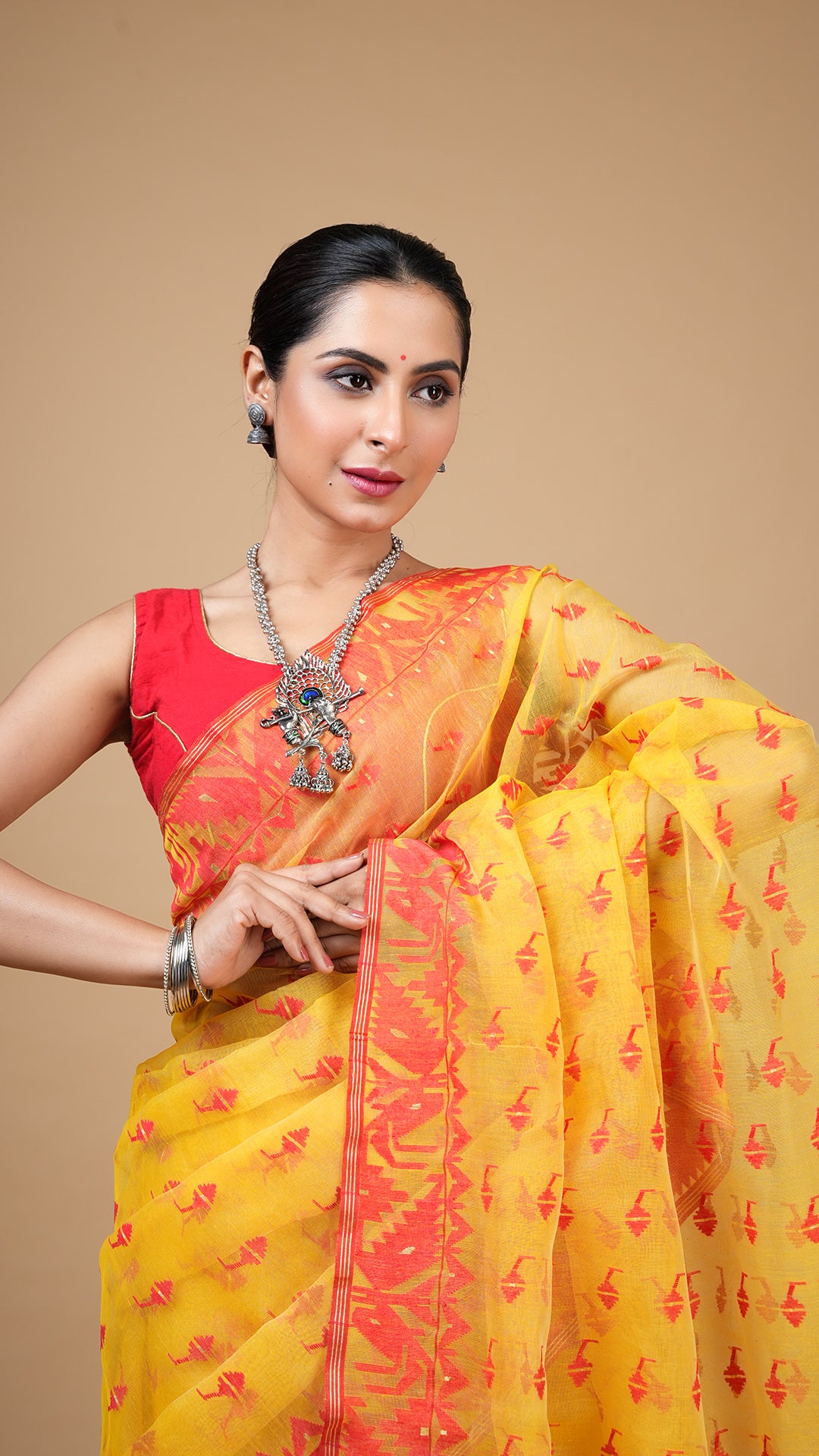 An yellow and red jamdani saree