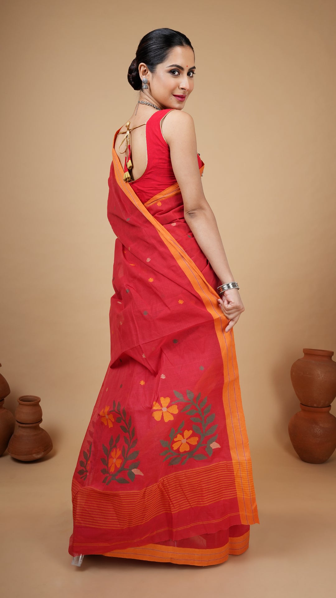 A red coloured dhakai saree
