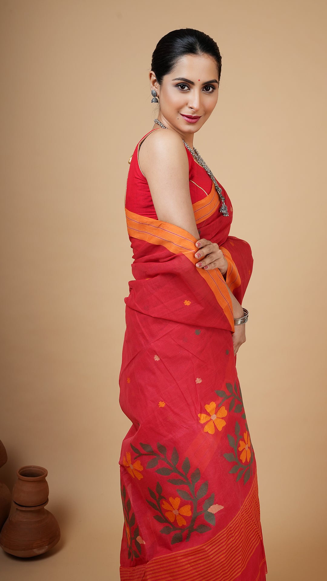 A red coloured dhakai saree