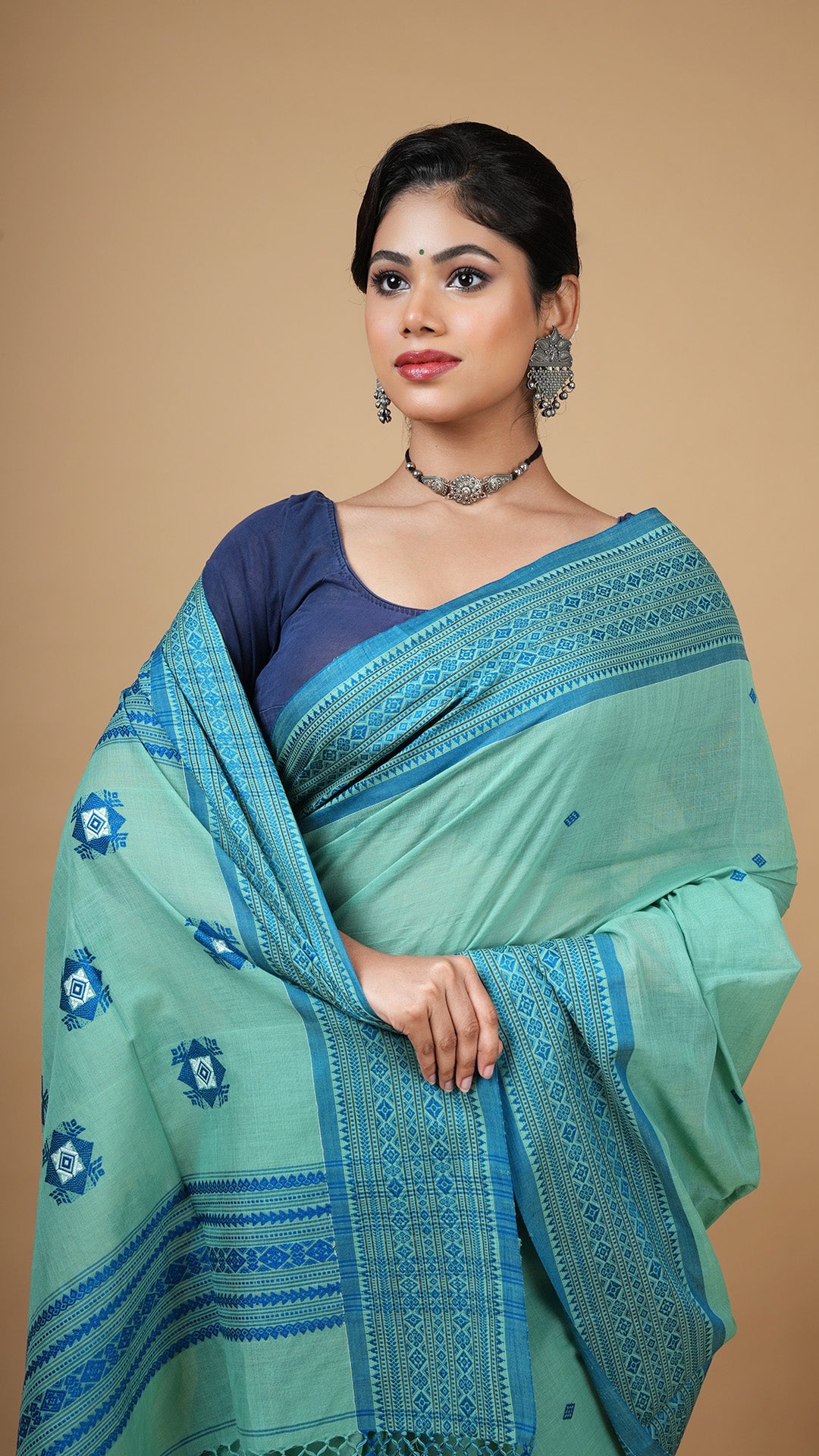 A green and blue tangail saree
