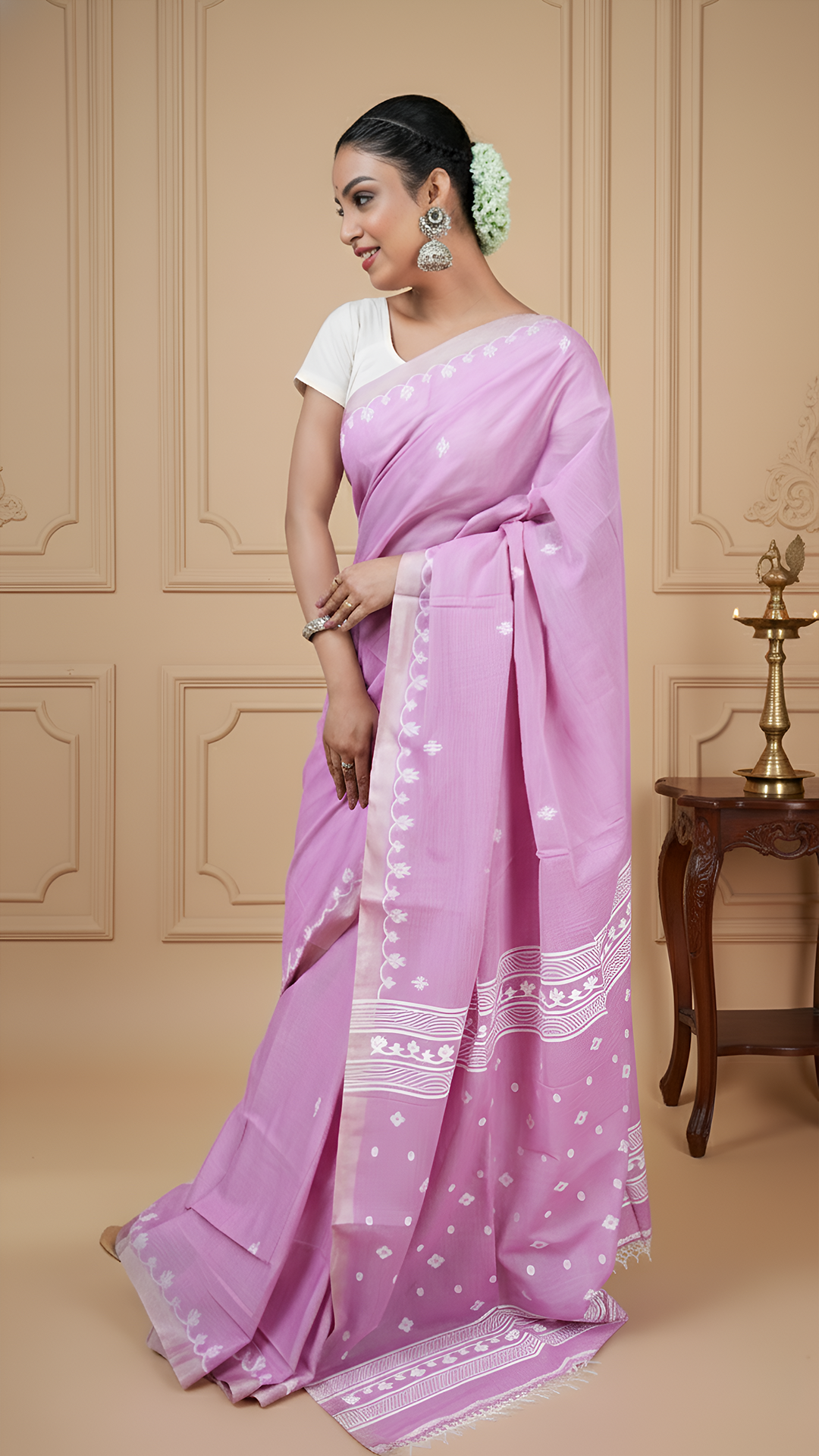 Dual tone mauve tangail saree in soft cotton with white woven butis and pallu. Elegant traditional wear for puja or daily use.