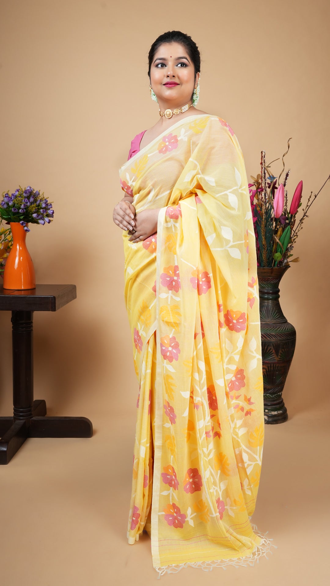 Lemon yellow soft cotton dhakai saree with floral weave in white, magenta, mustard and pink across body, border and pallu.