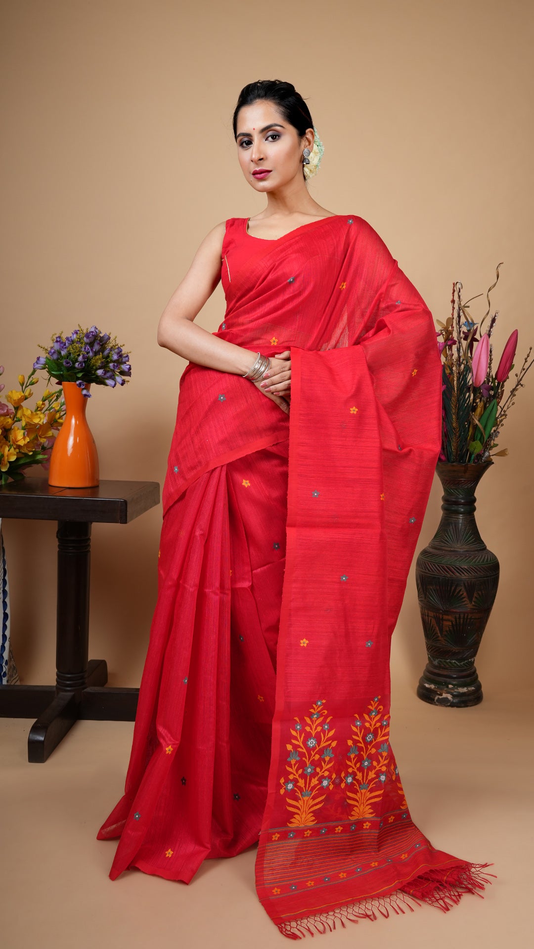 Red raw silk saree with no border, multicolor woven butis and muslin silk pallu in yellow, green and white. Premium festive wear.