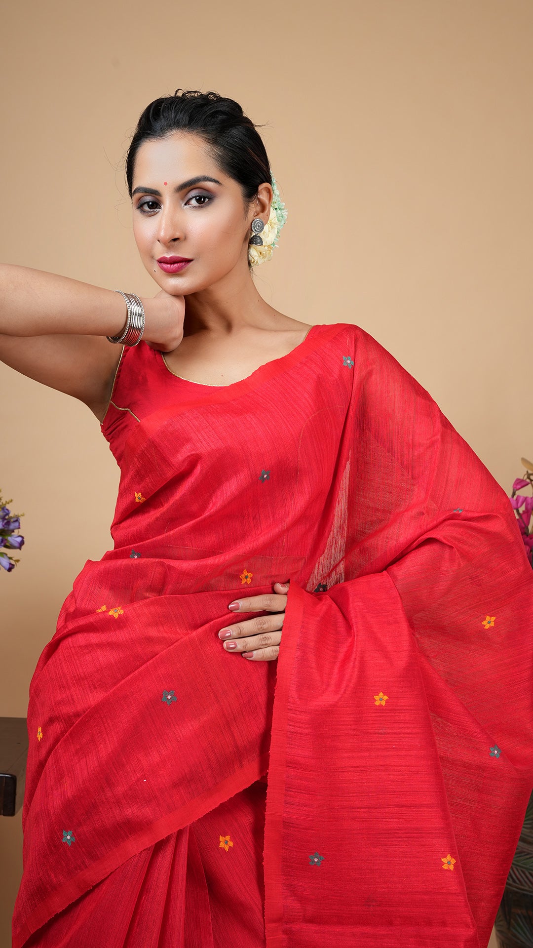 A red with multi colour raw silk saree