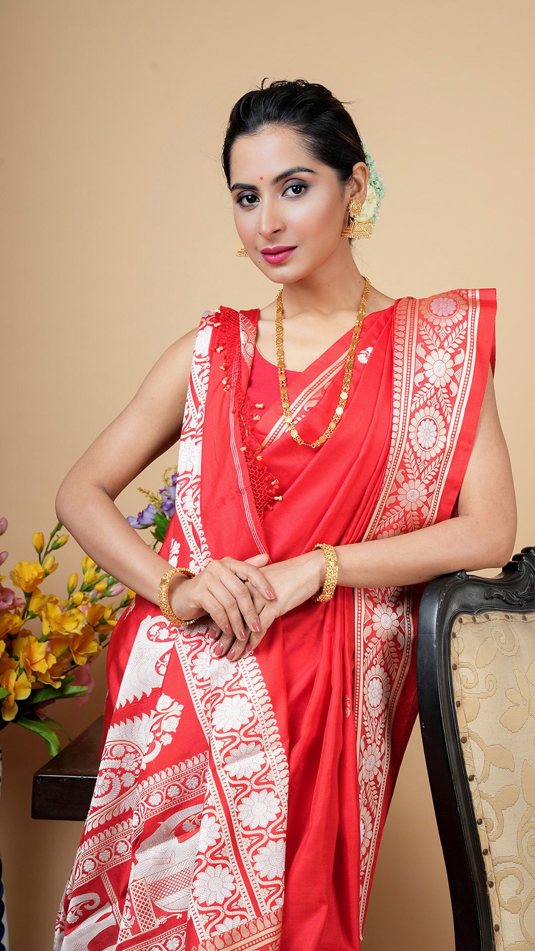Red silk Tangail saree with white and beige woven butis and border, featuring animal motif pallu. Perfect for weddings, puja, or festive occasions.