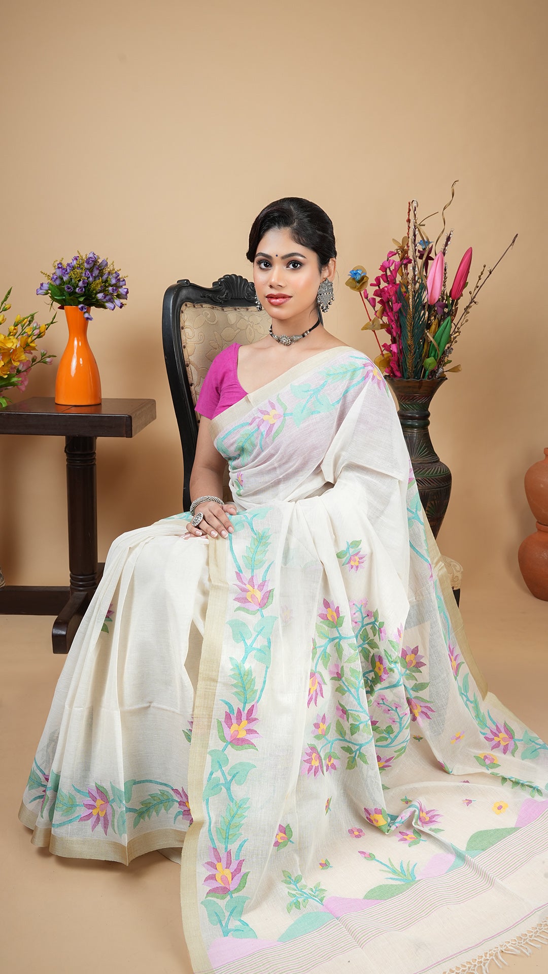 An off white with multi colour dhakai saree