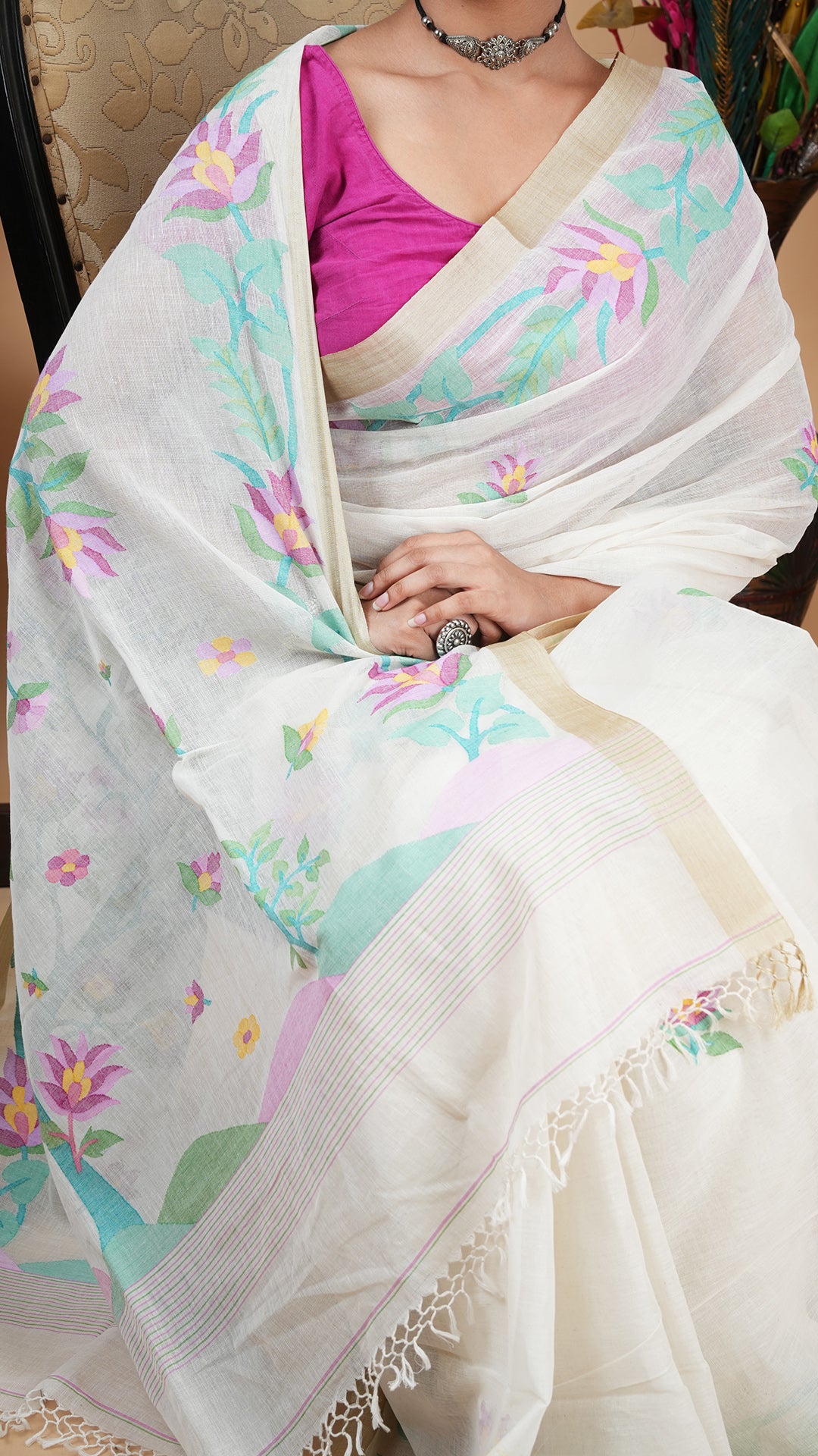 An off white with multi colour dhakai saree
