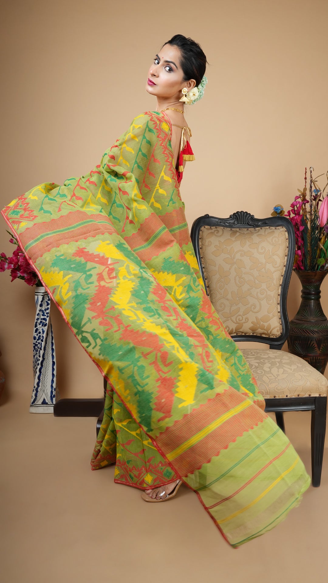 A green multi coloured jamdani saree