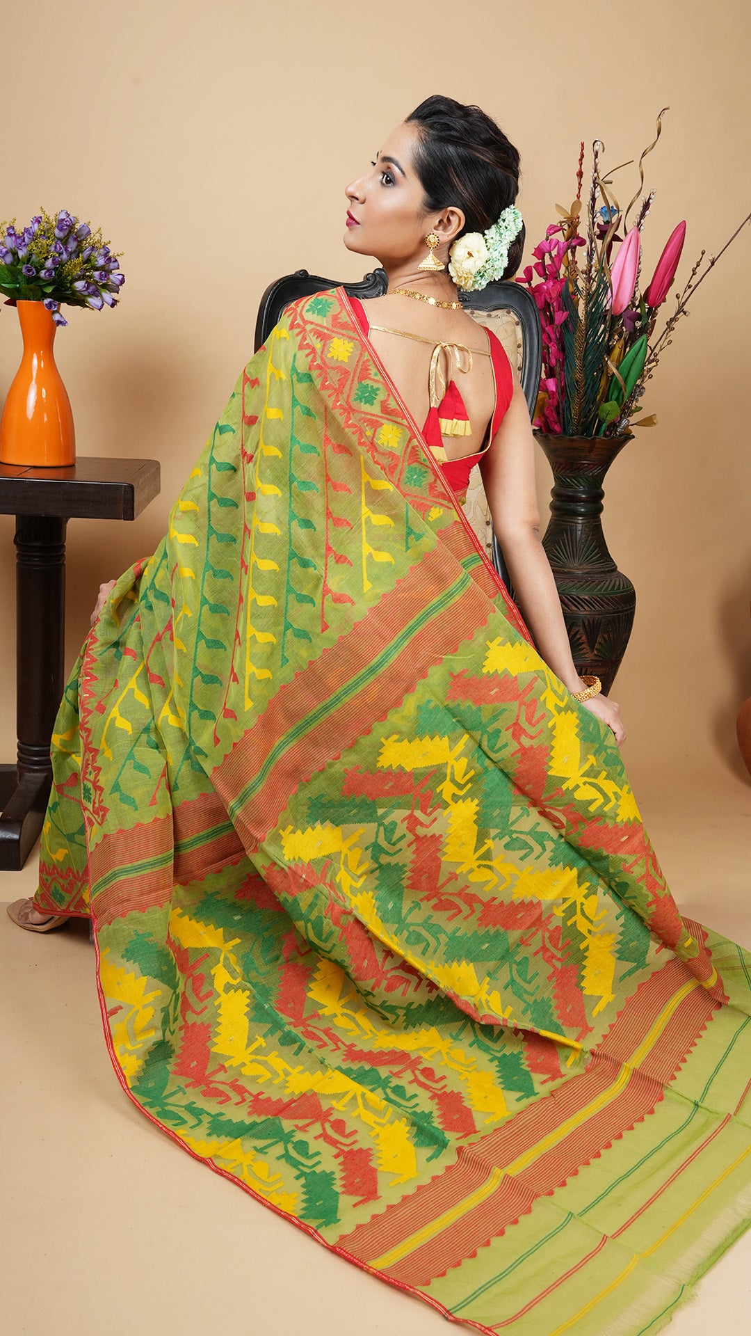 A green multi coloured jamdani saree