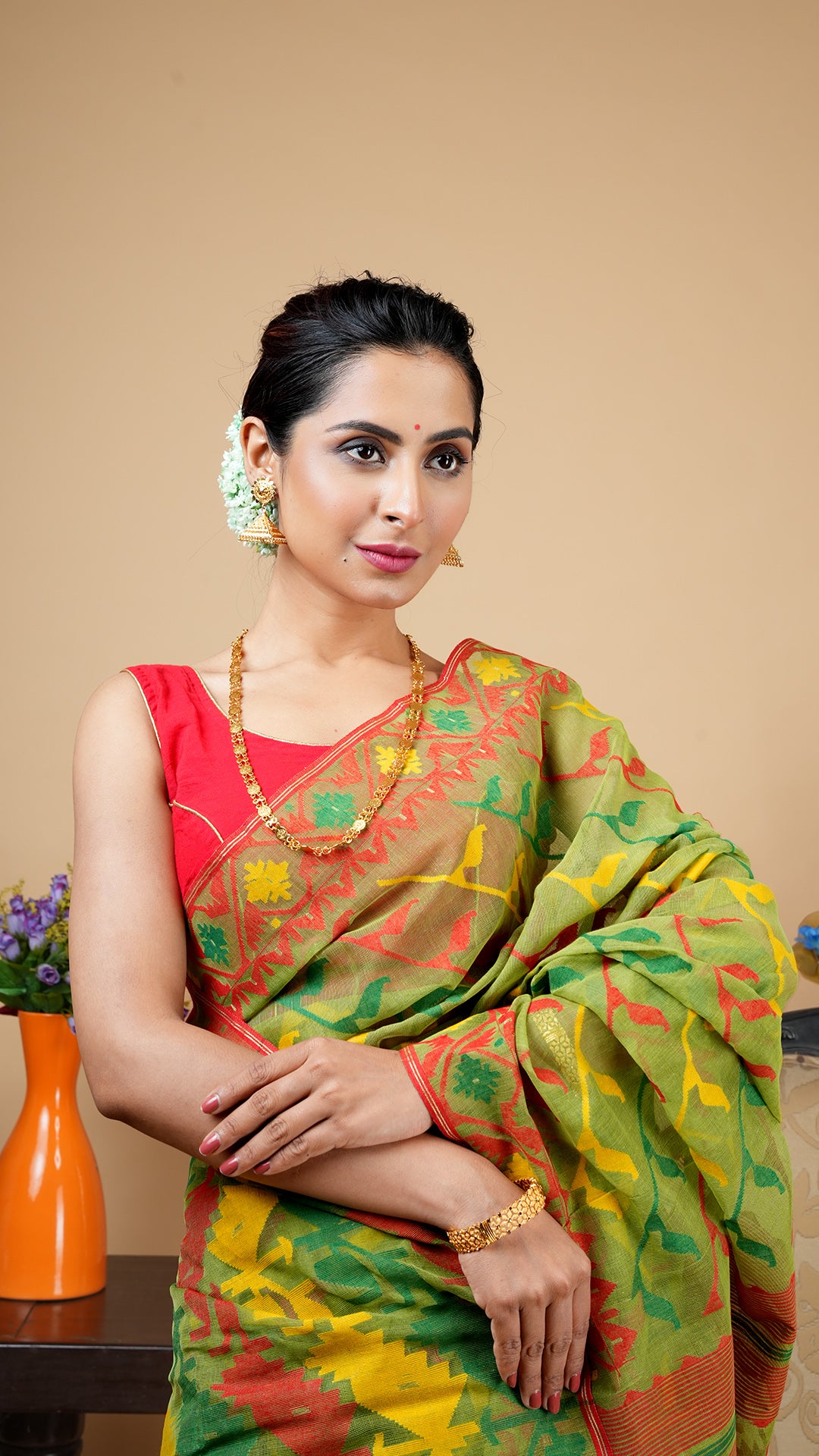 A green multi coloured jamdani saree