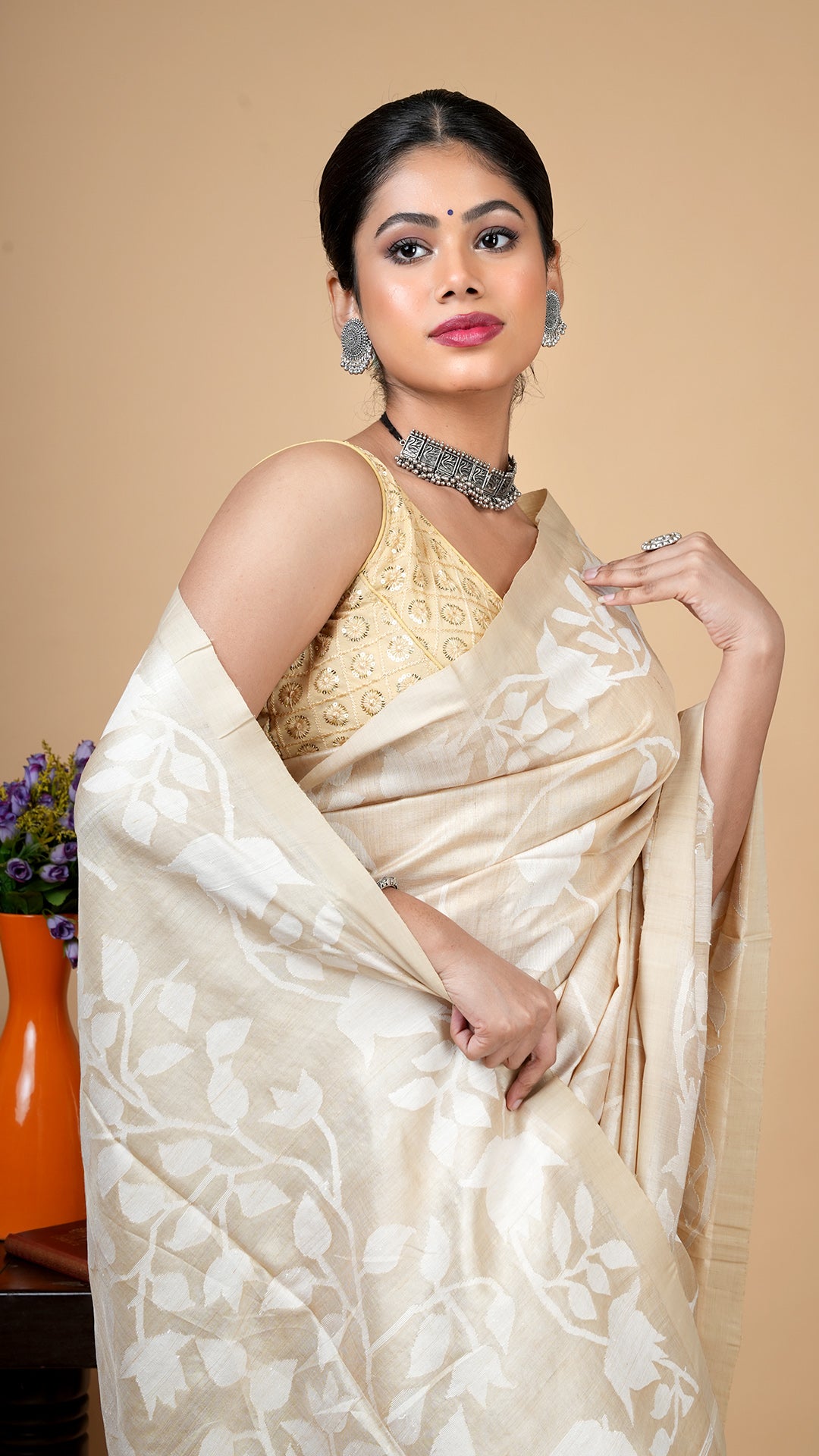 A tassar all over saree close-up in off white dhakai weave, detailed floral motifs with rich texture and elegant blouse styling