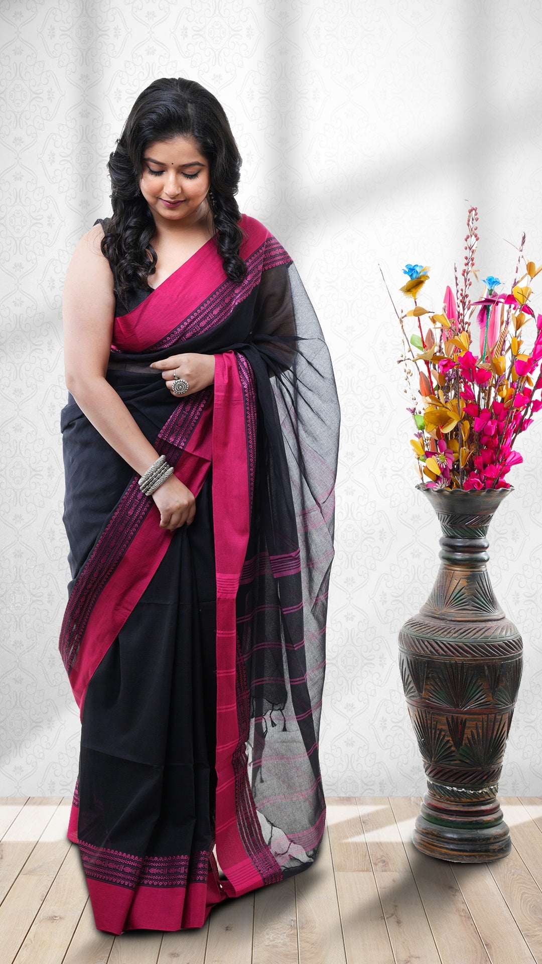 A soft cotton Tangail saree. A black base Tangail saree in soft cotton. The pallu is handwoven with stripes. Crafted with soft cotton Warp and weft. Standard 5.5-meter length.