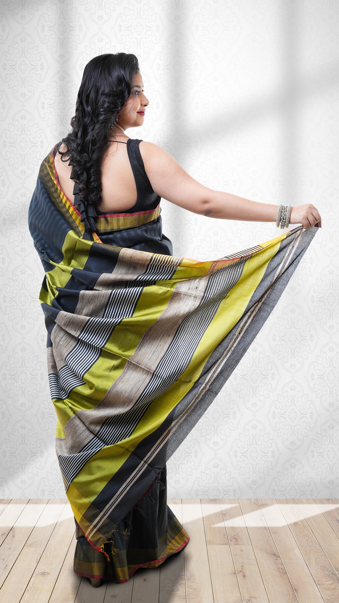A black silk saree. A black Tangail saree silk saree with self stripes. The pallu is deep green and black. Crafted with silk Warp and weft. Standard 5.5-meter length. Includes matching blouse piece. Tangail saree, handloom silk sari.