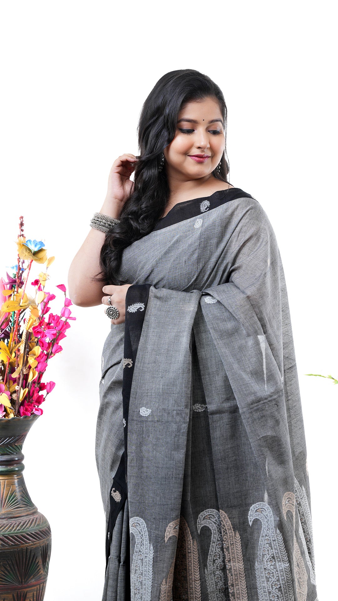 A grey cotton saree. A soft cotton cotton saree in grey colour. The border and pallu have thread stripes. Crafted with soft cotton Warp and weft. Standard 5.5-meter length. Includes matching blouse piece. Tangail saree, cotton saree.