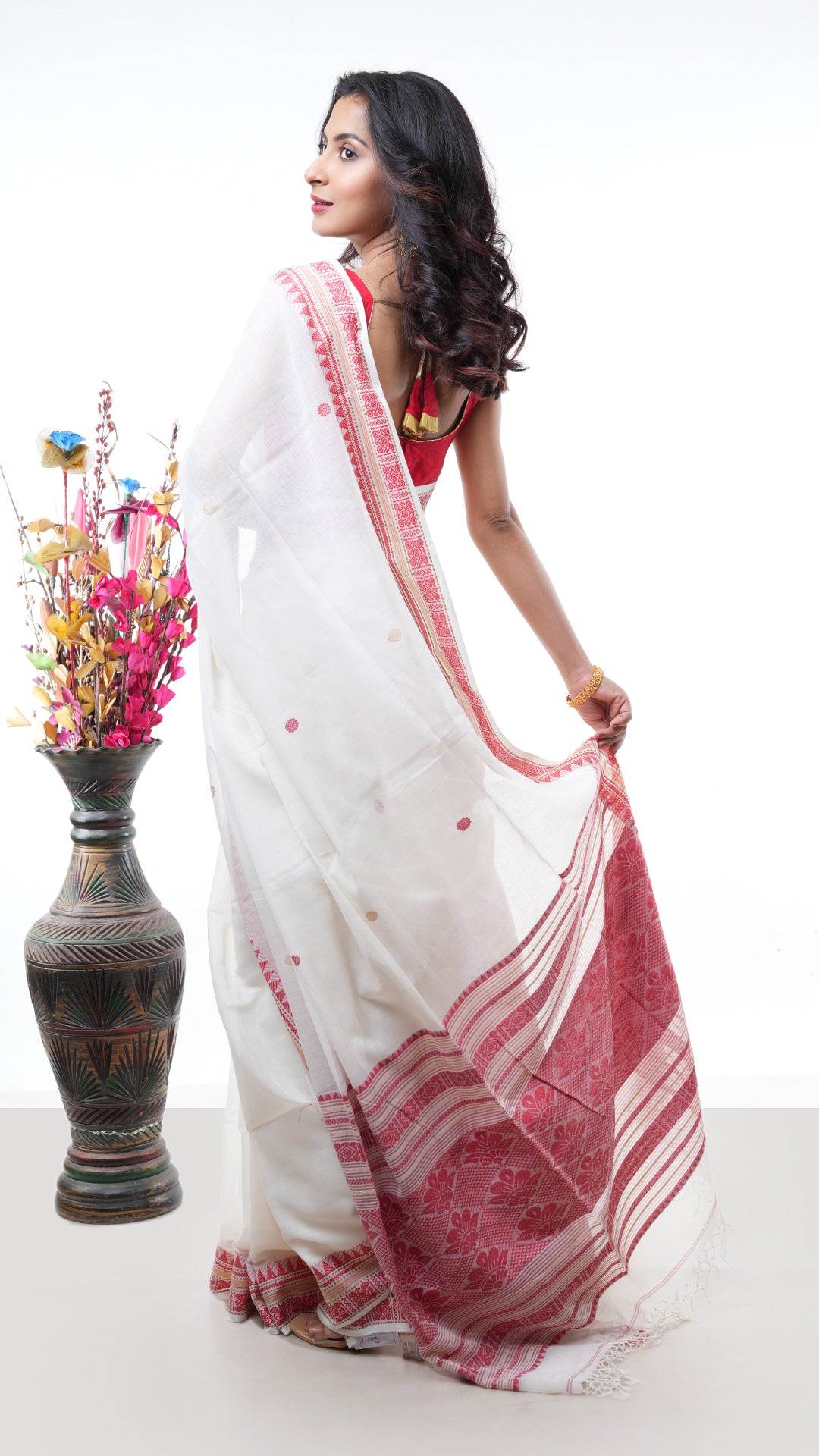 An off white red cotton saree