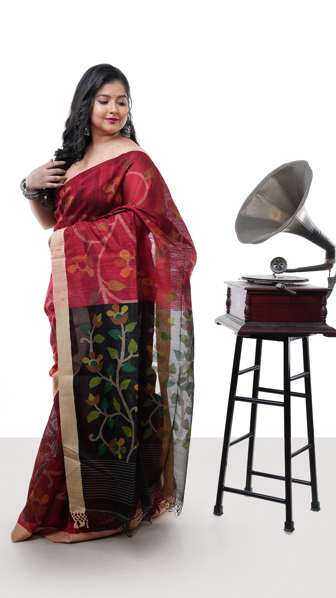 A blackish red raw silk saree. A raw silk sari with red-beige stripes. Crafted with muslin silk Warp and raw silk weft. Standard 5.5-meter length. Includes matching blouse piece. handloom silk sari