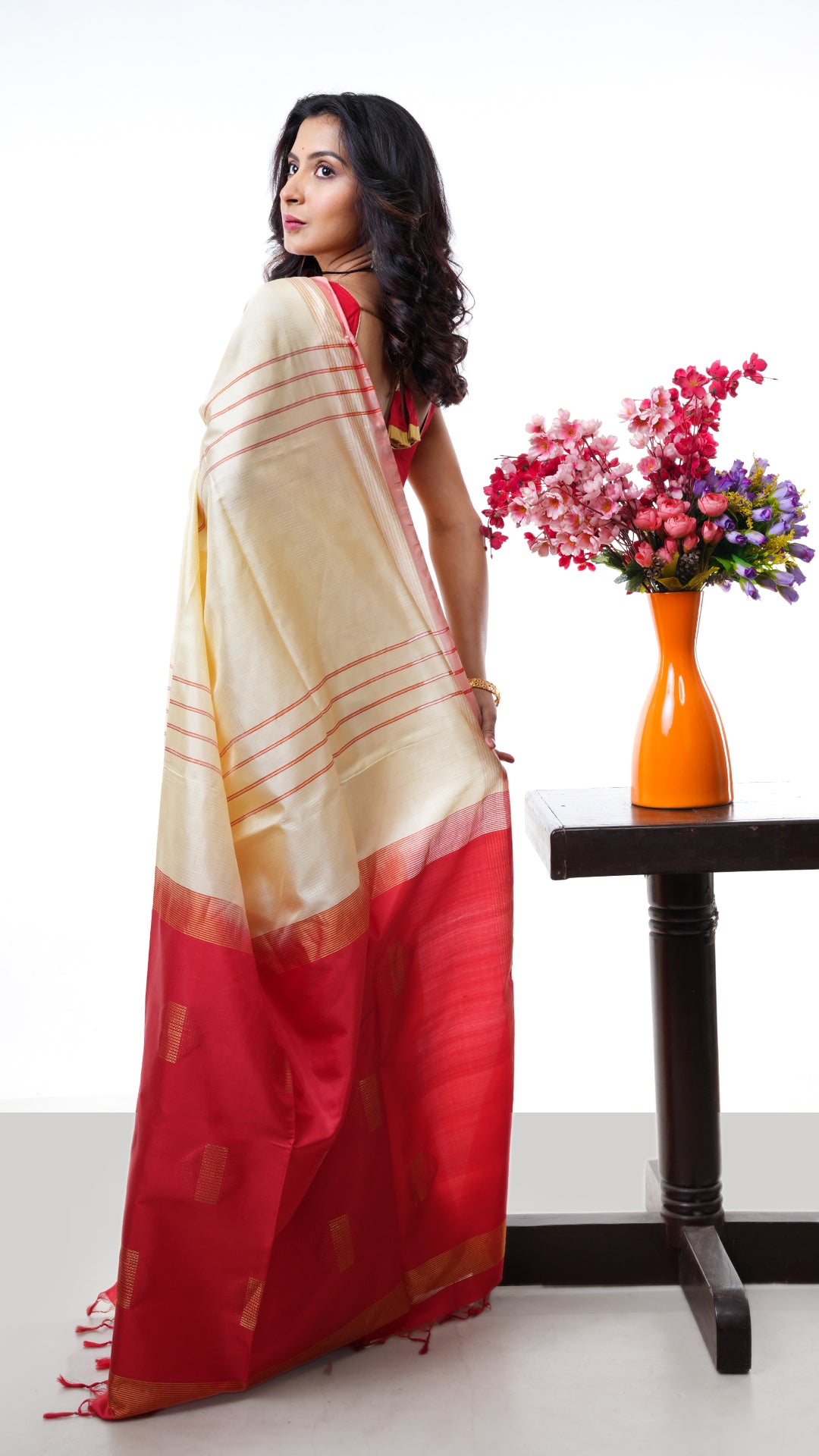 An off white red silk saree