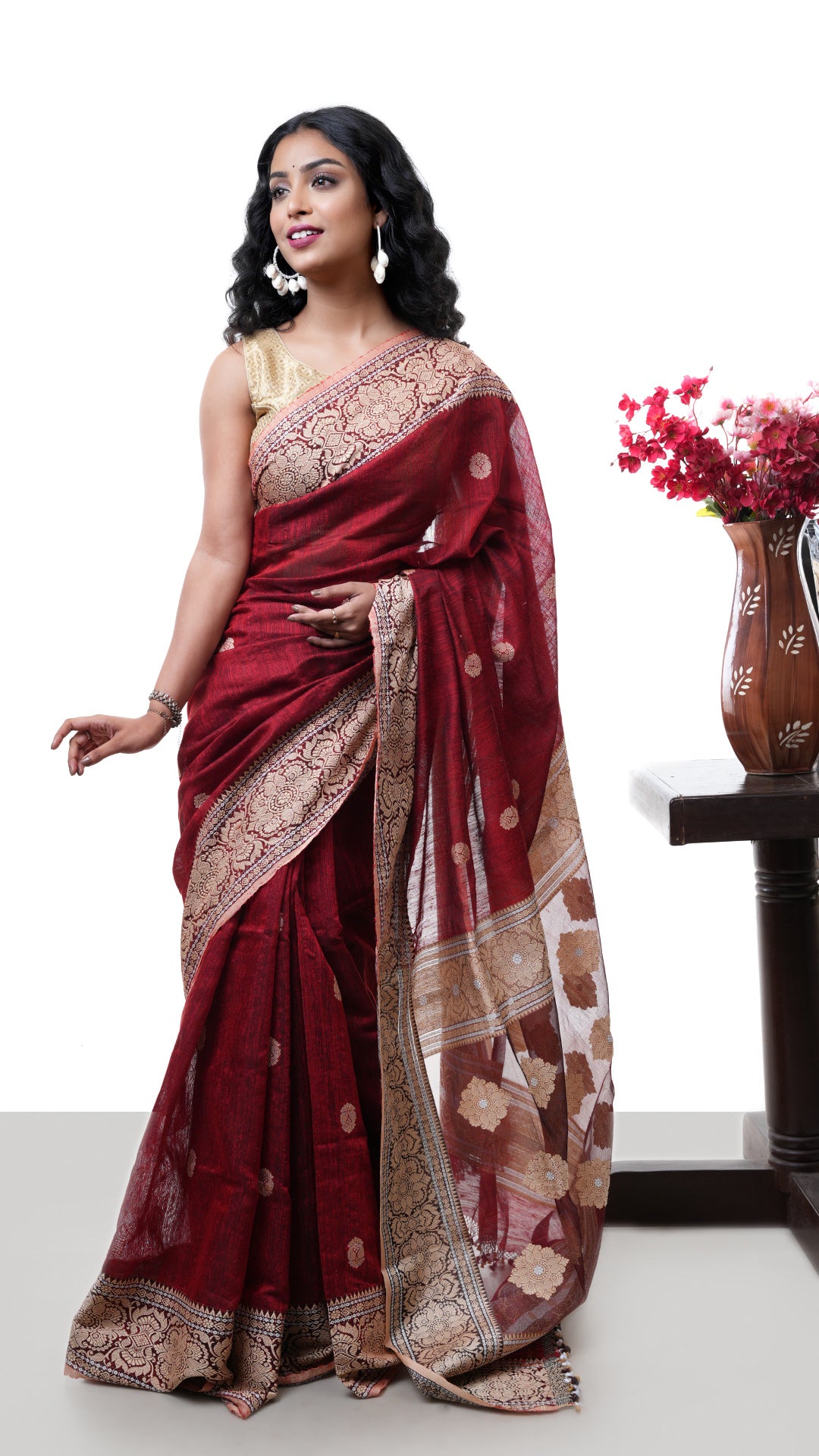 A raw silk saree in maroon colour. A maroon raw silk sari with fine weave. Crafted with raw silk Warp and weft. Standard 5.5-meter length. Includes matching blouse piece. handloom silk sari