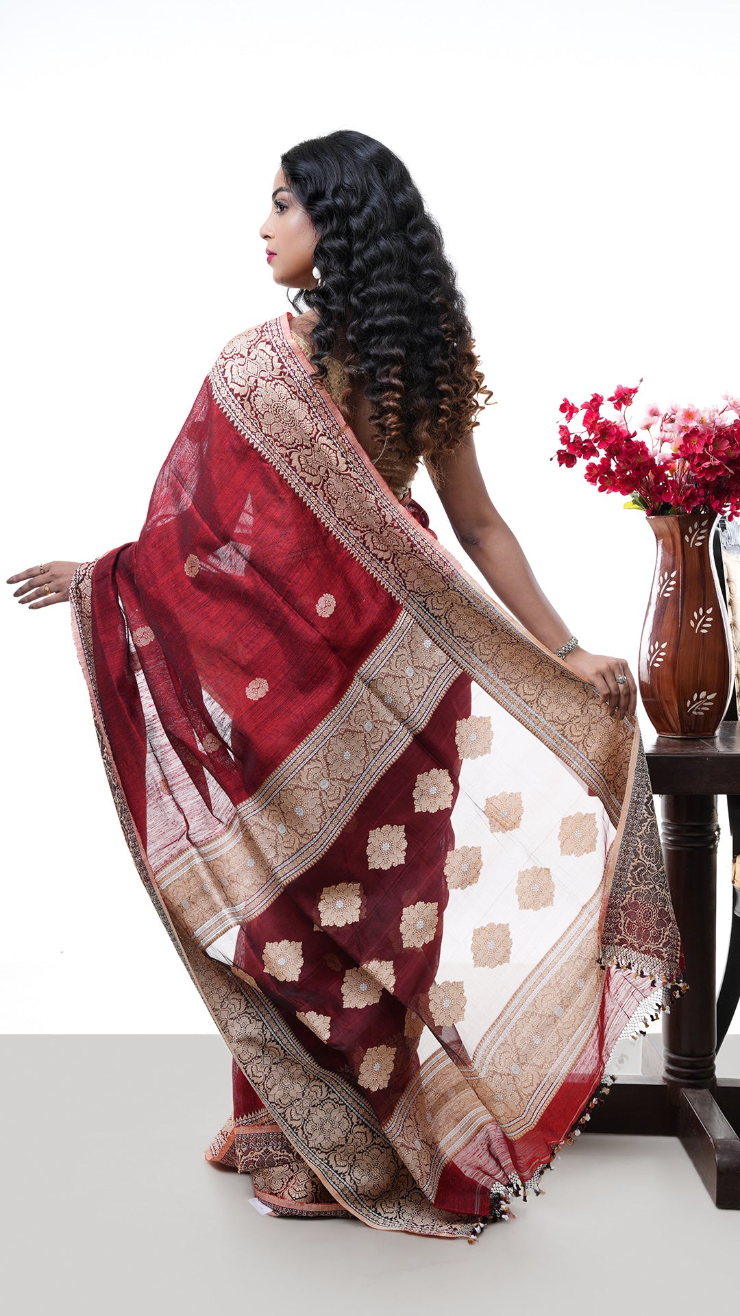 A raw silk saree in maroon colour